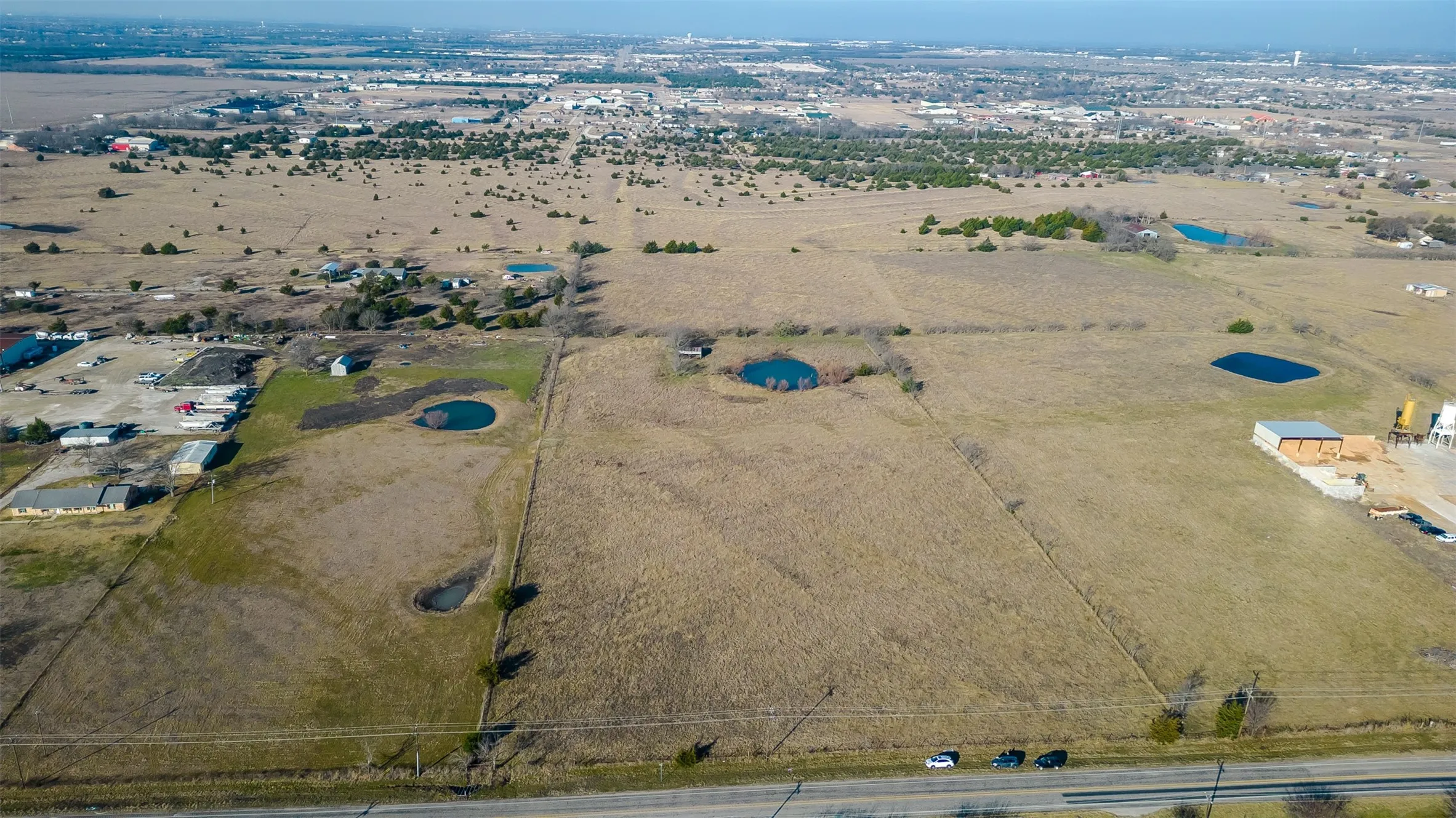 Expansive land parcel featuring  a distant urban landscape