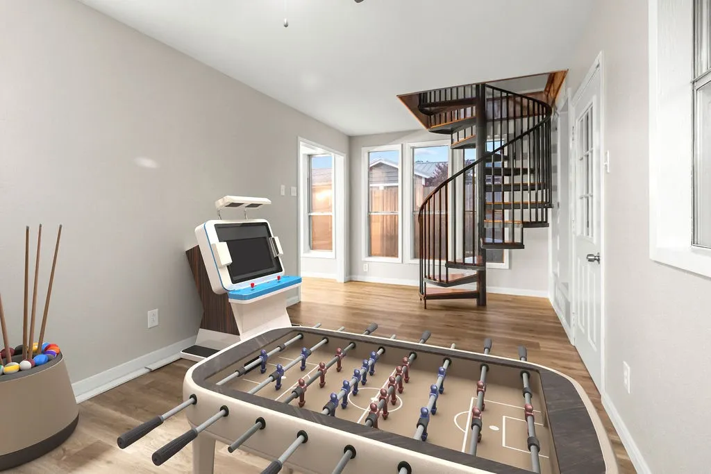 Spiral staircase with dark metal railings, wood-finish flooring, multi-pane windows, and a panel door with glass inserts
