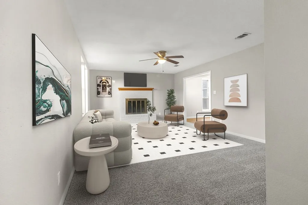 Living area featuring a fireplace with a white mantel, ceiling fan with integrated lighting, and carpet flooring