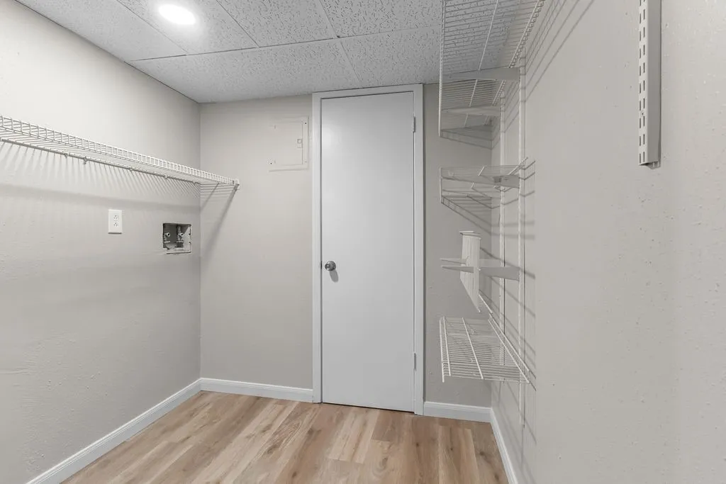 Wood-finish flooring, recessed lighting, and built-in wire shelving