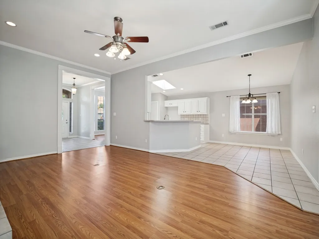 Open-concept living area featuring wood-finish flooring, recessed lighting, and a ceiling fan