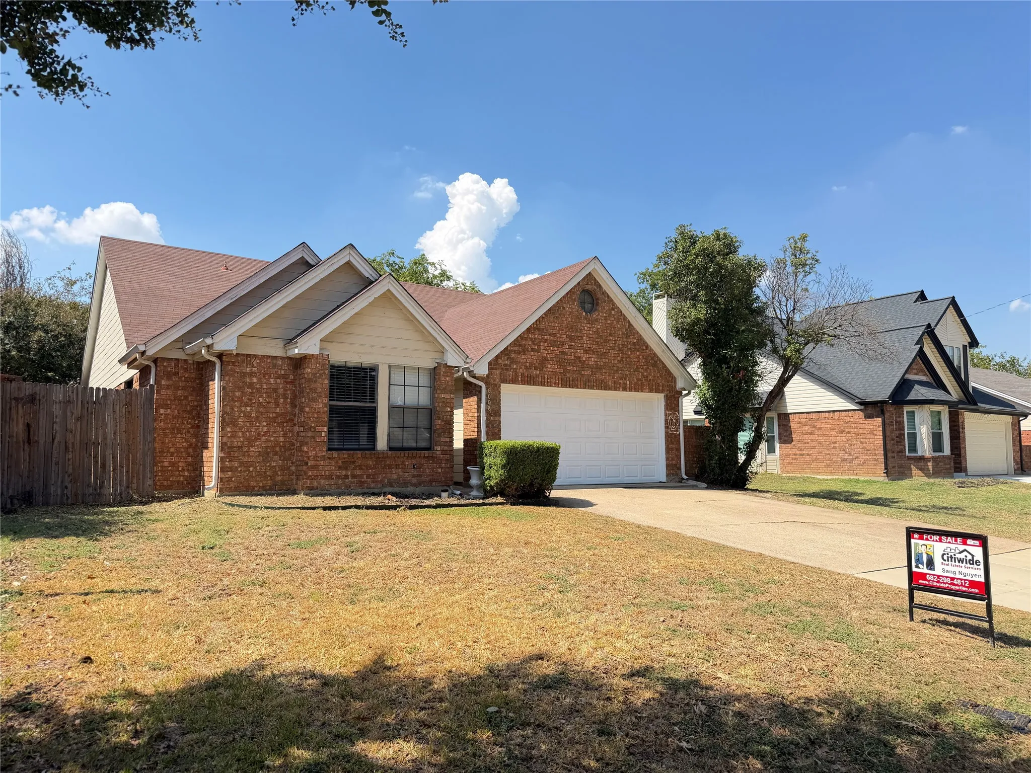 Brick exterior with a gabled roof and attached two-car garage