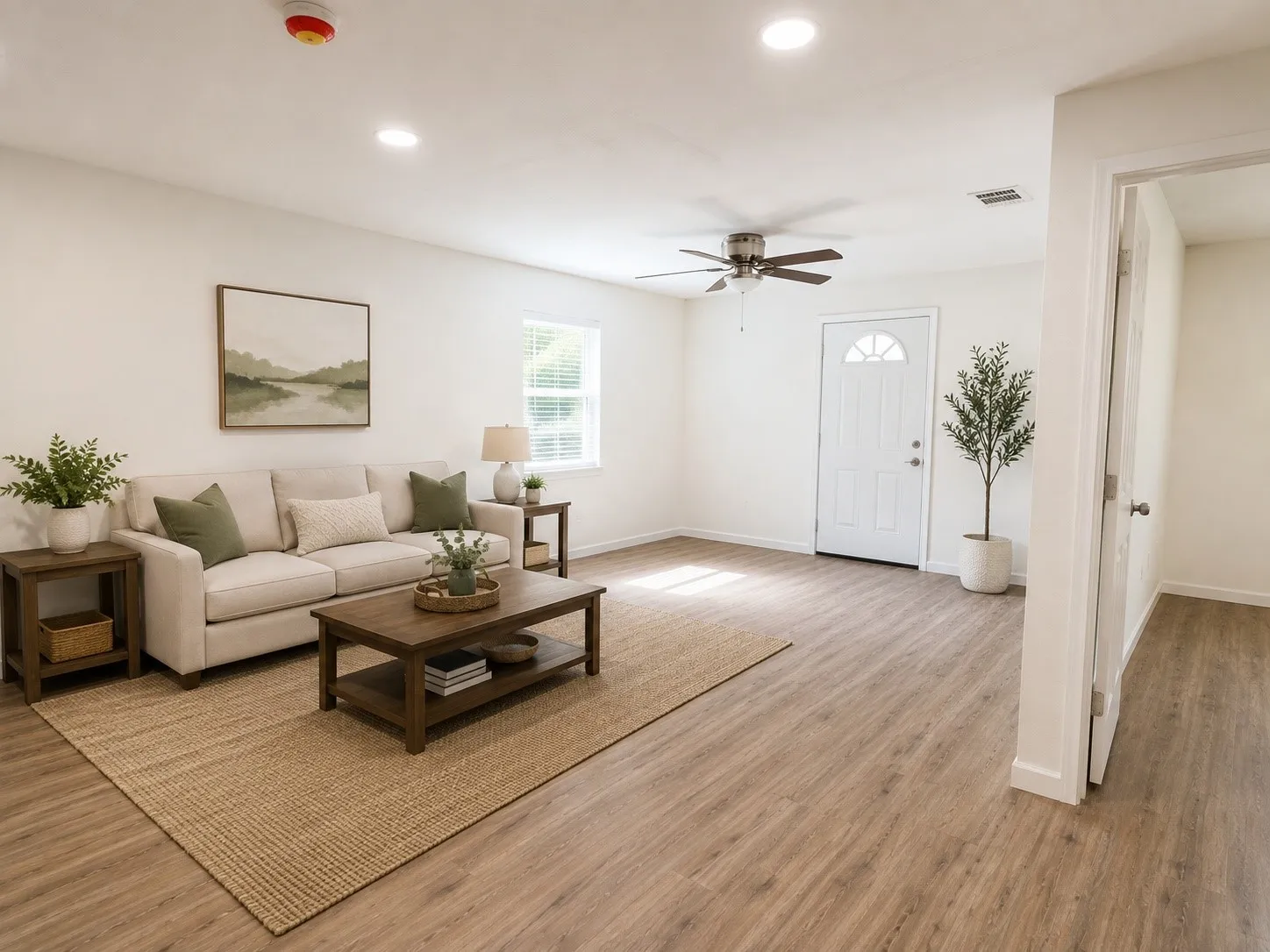 Open-concept living area featuring wood-finish flooring, recessed lighting, and a ceiling fan