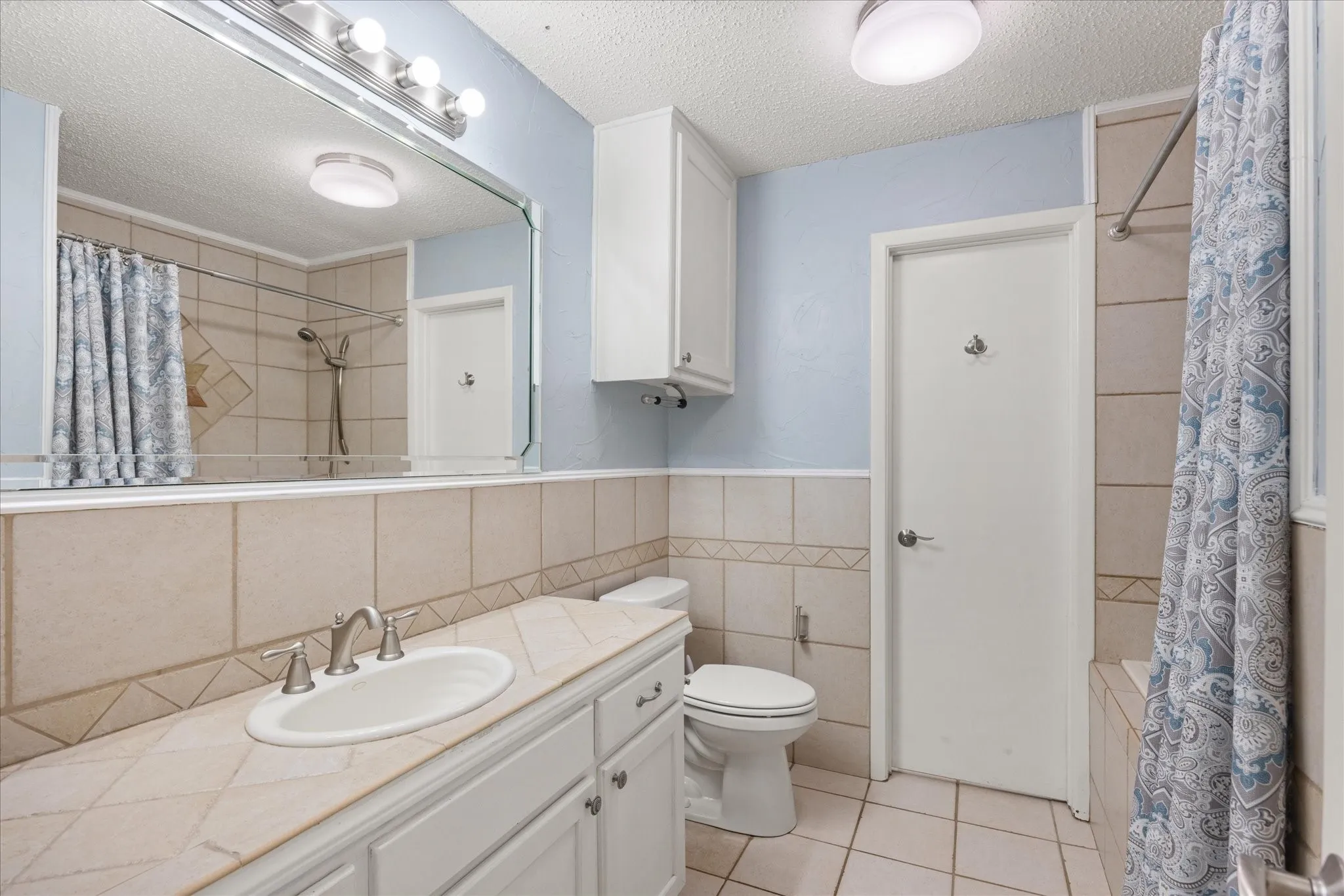 Vanity with an integrated sink and tiled countertop