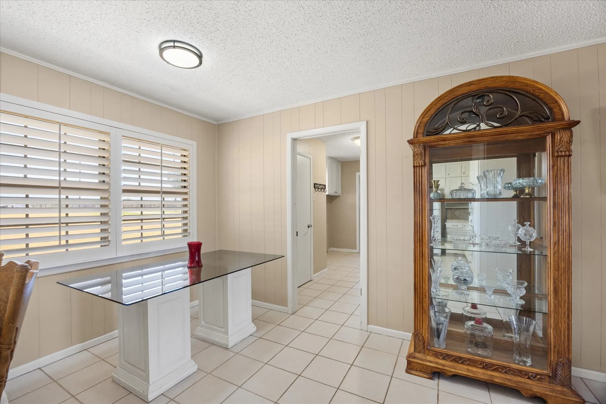 Window with horizontal blinds and an overhead light fixture