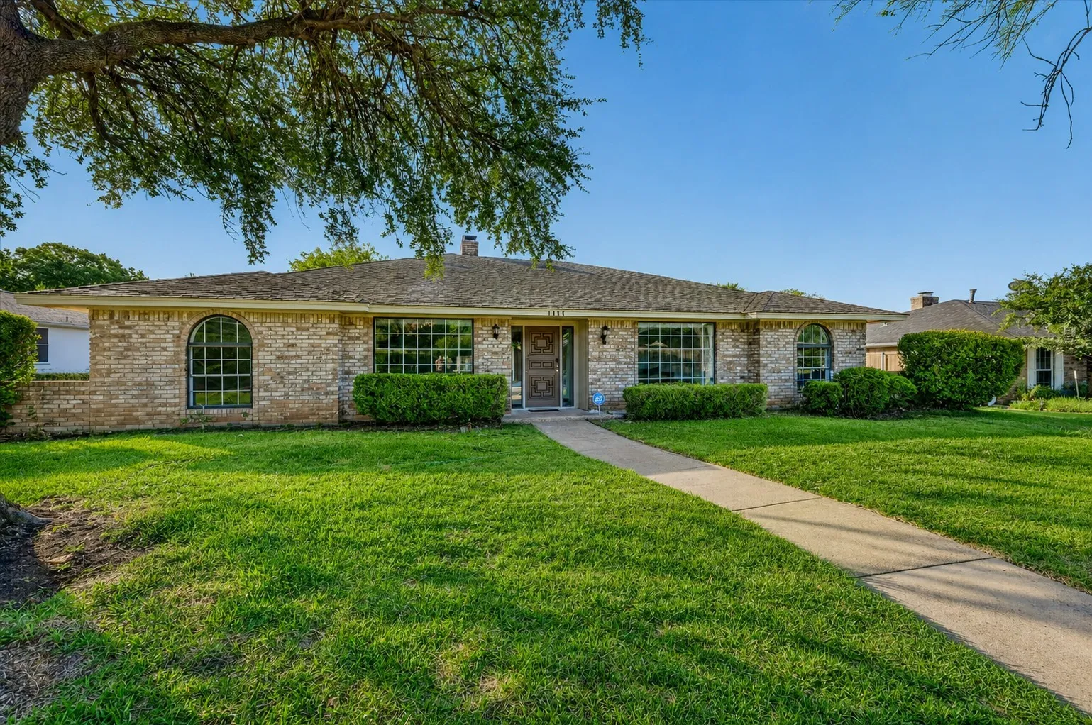 Brick exterior with a shingled roof