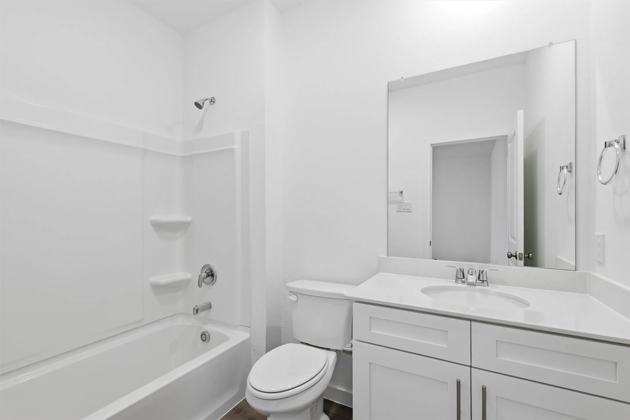 White vanity with a light-toned countertop and an integrated sink
