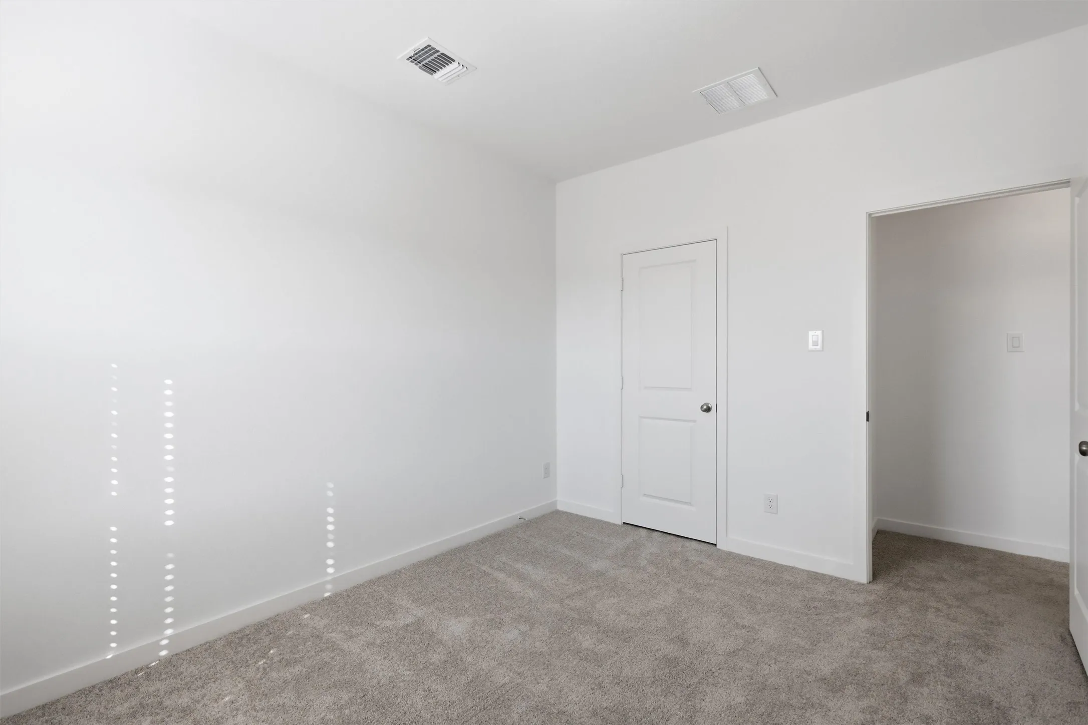 Neutral wall color, carpet flooring, and white trim
