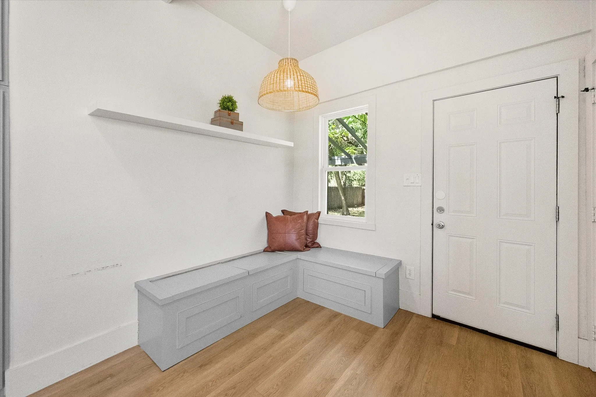 Entry features built in bench with storage.