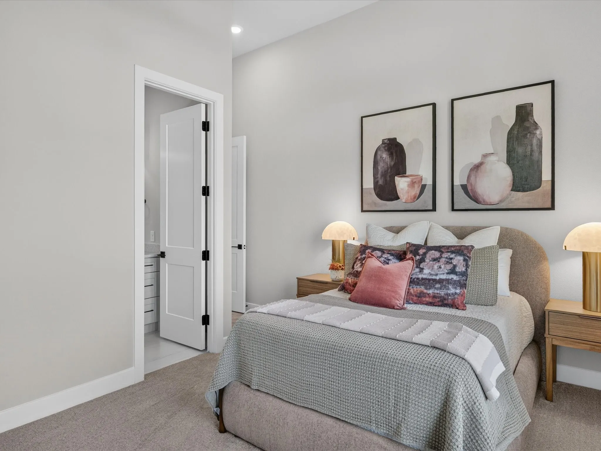 Wall-to-wall carpeting, recessed ceiling lighting, and a solid core interior door with matte black hardware