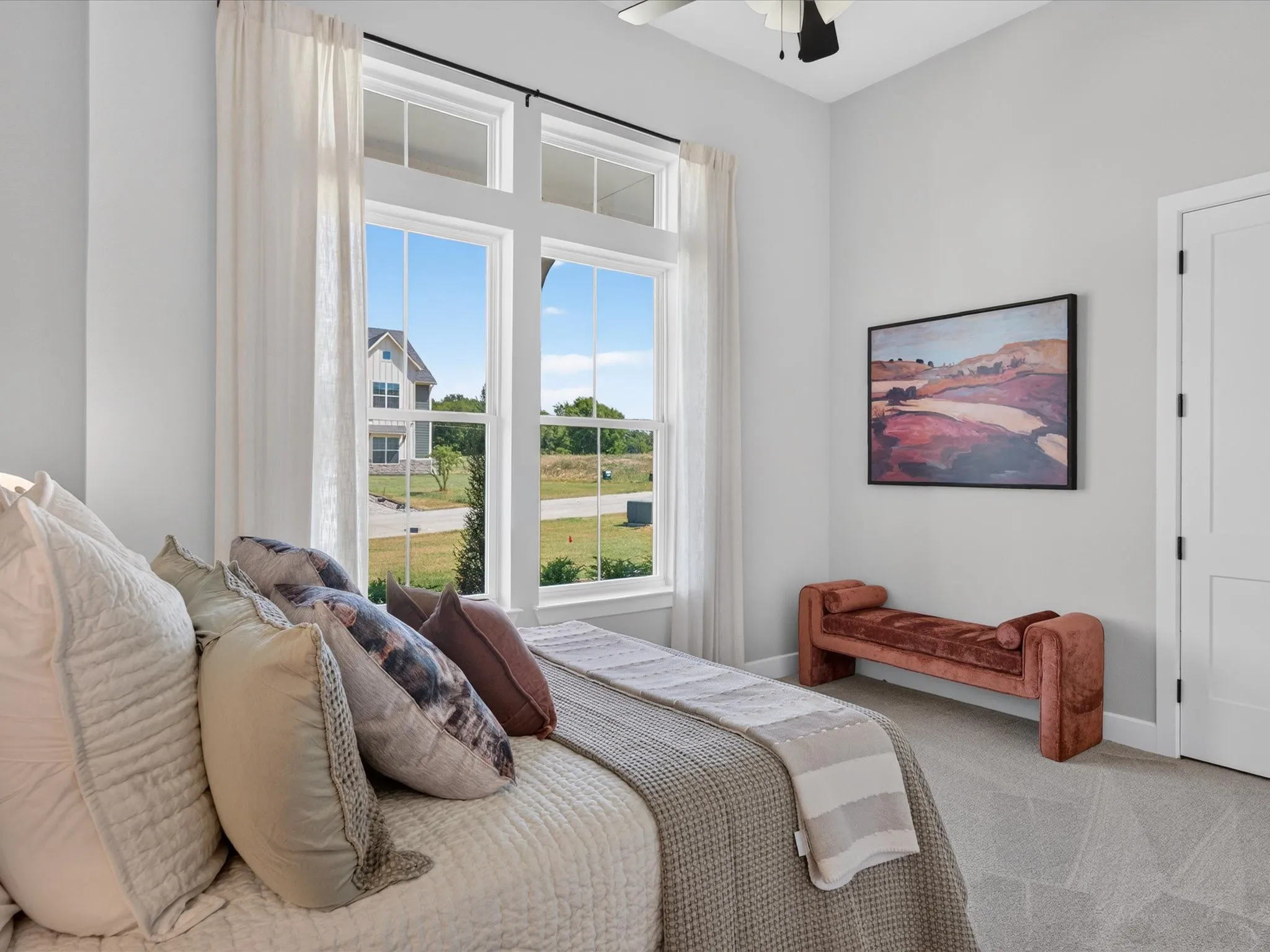 Tall windows with white trim, light gray walls, and light gray carpet