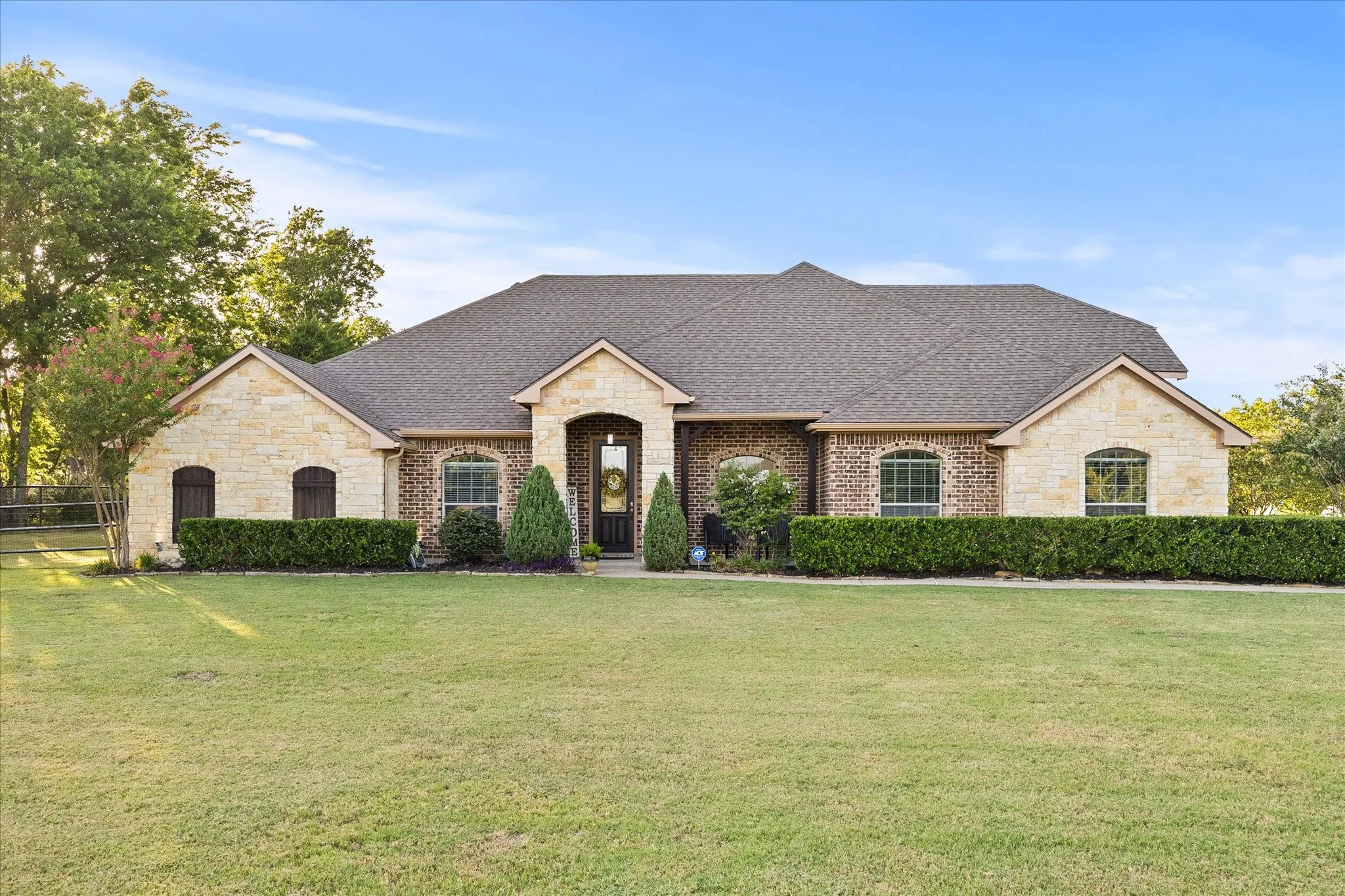 Stone and brick exterior with a prominent arched entry