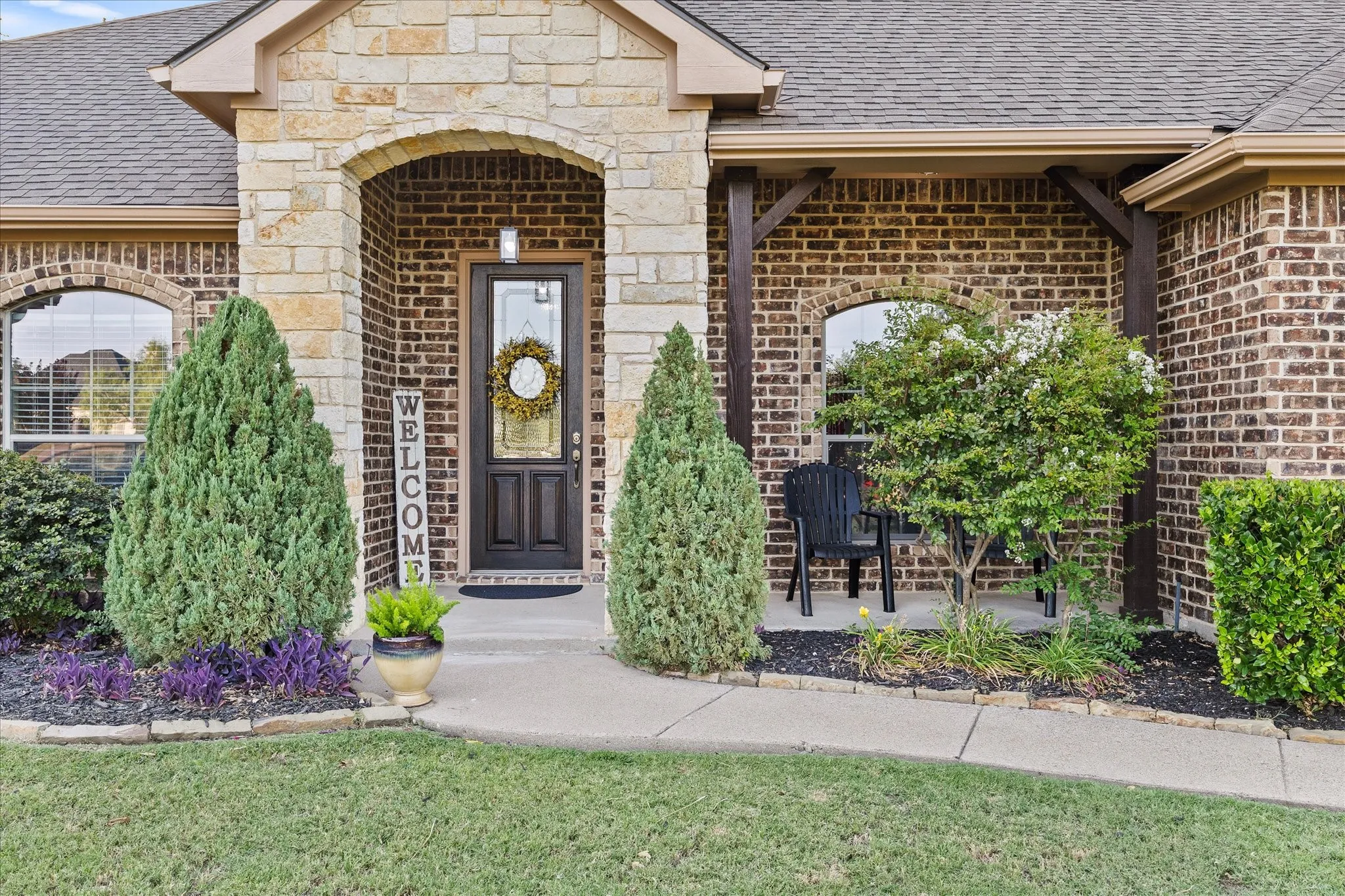 Brick and stone exterior with an arched entryway