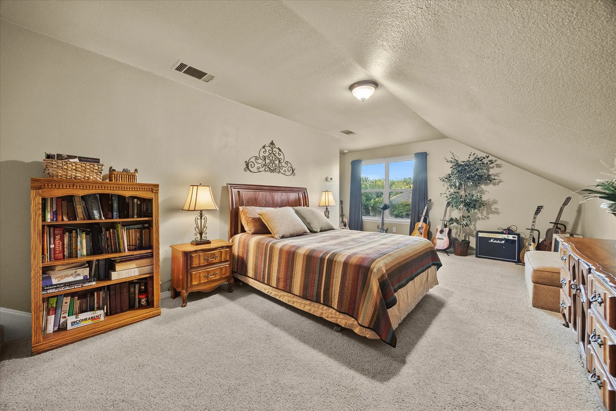 Carpeted flooring, vaulted ceiling, built-in window, and recessed lighting