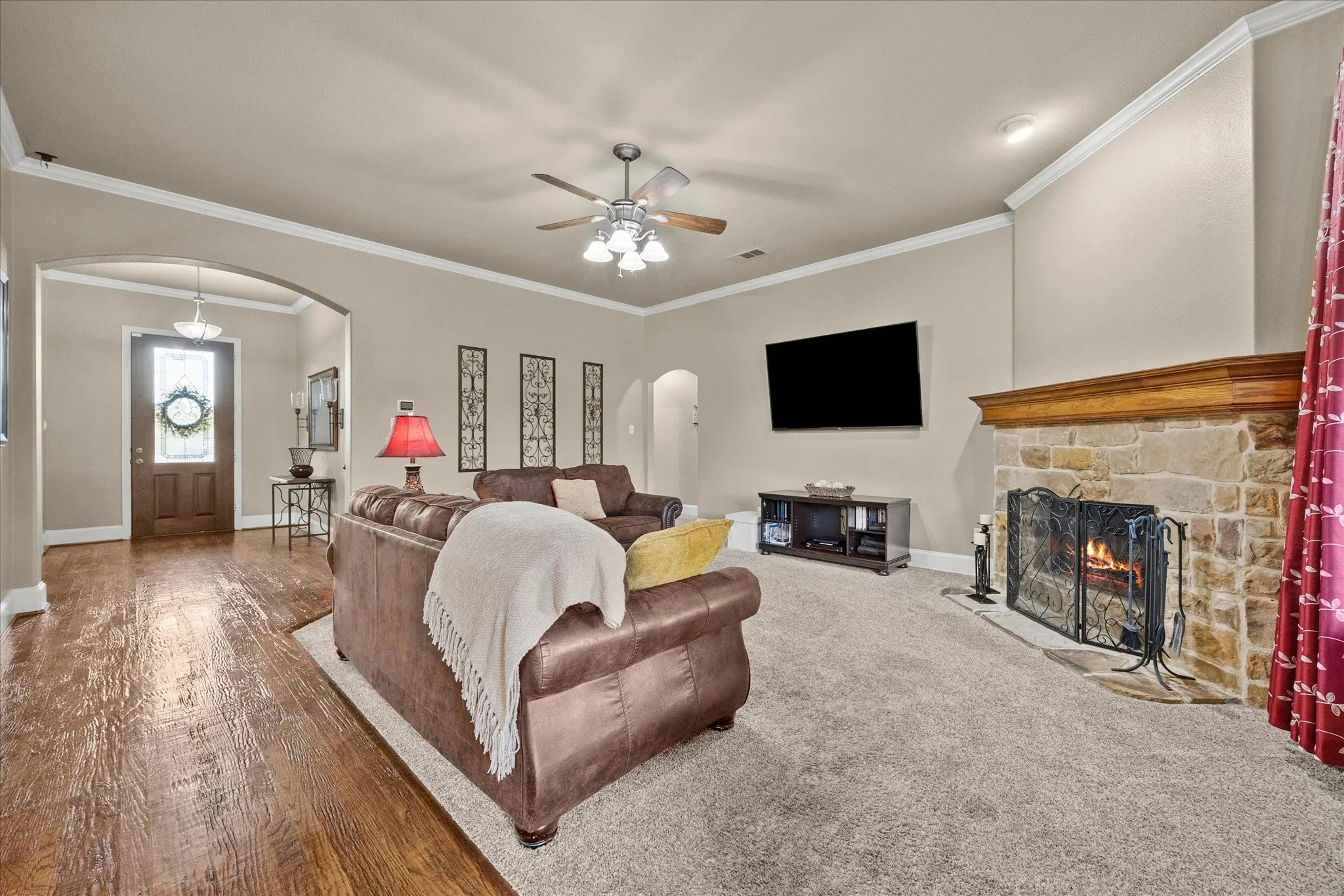 Stone fireplace with a wood-finish mantel and hearth