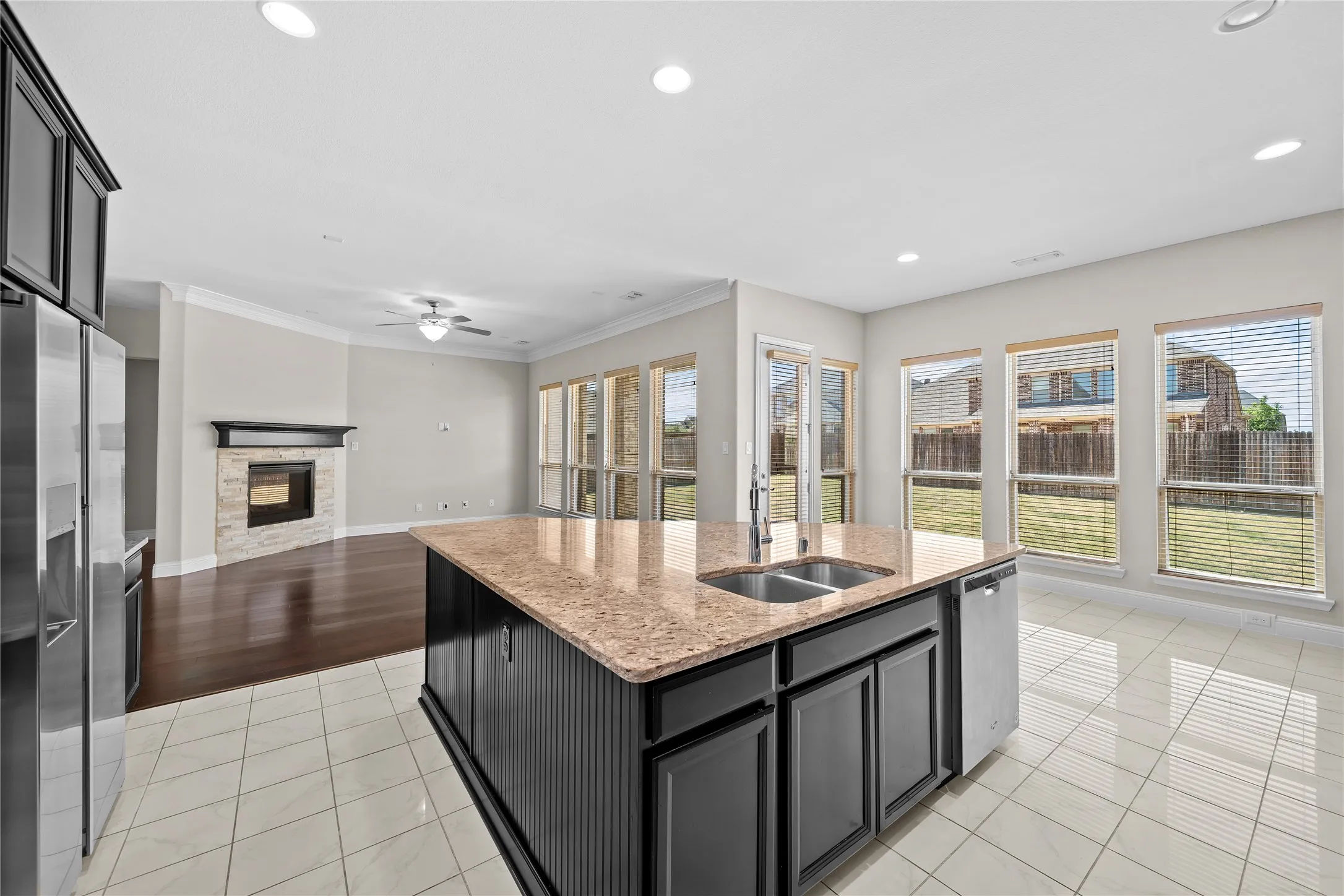 Kitchen island with stone-finish countertop and integrated double basin sink