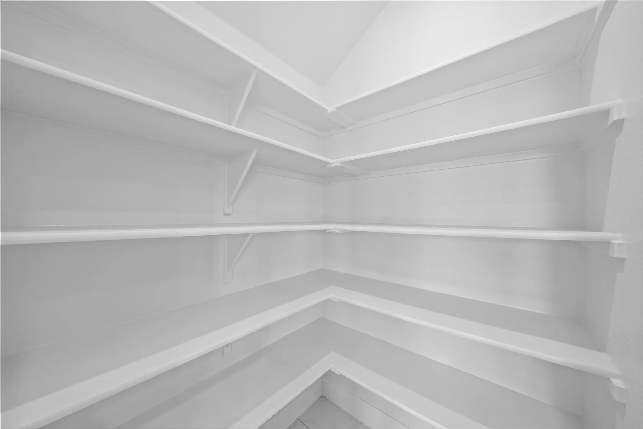 Extensive corner shelving system with multiple tiers, offering ample storage capacity