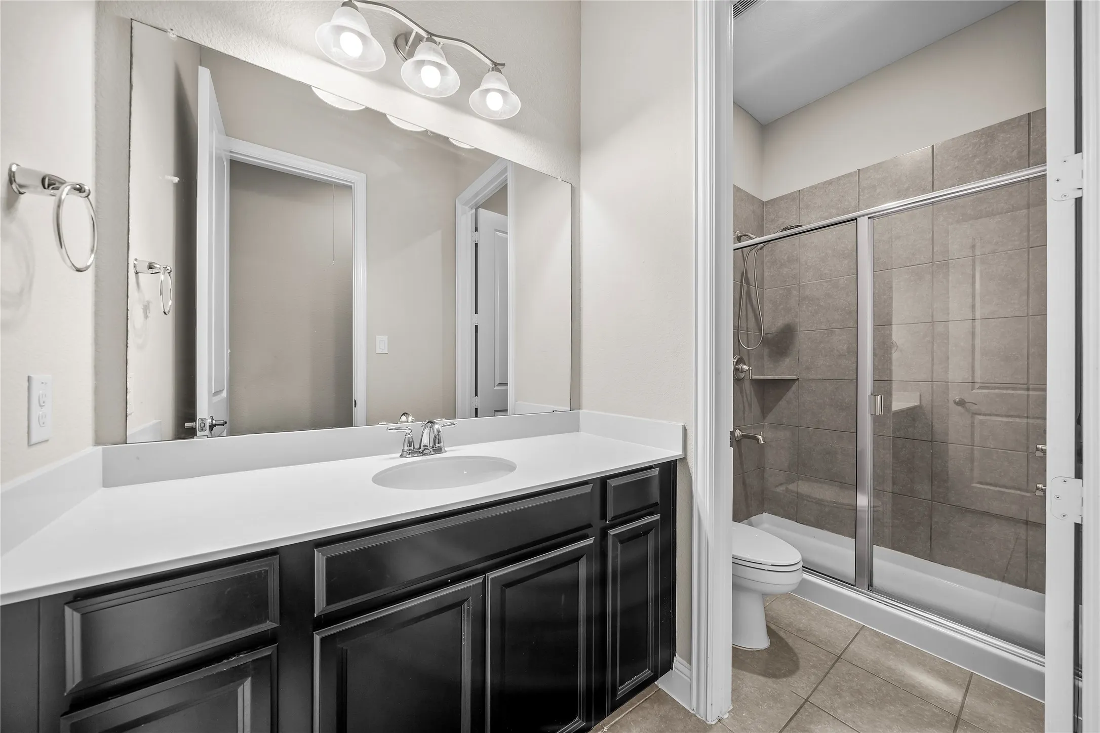 Vanity with an integrated sink, polished chrome faucet, and dark wood cabinetry