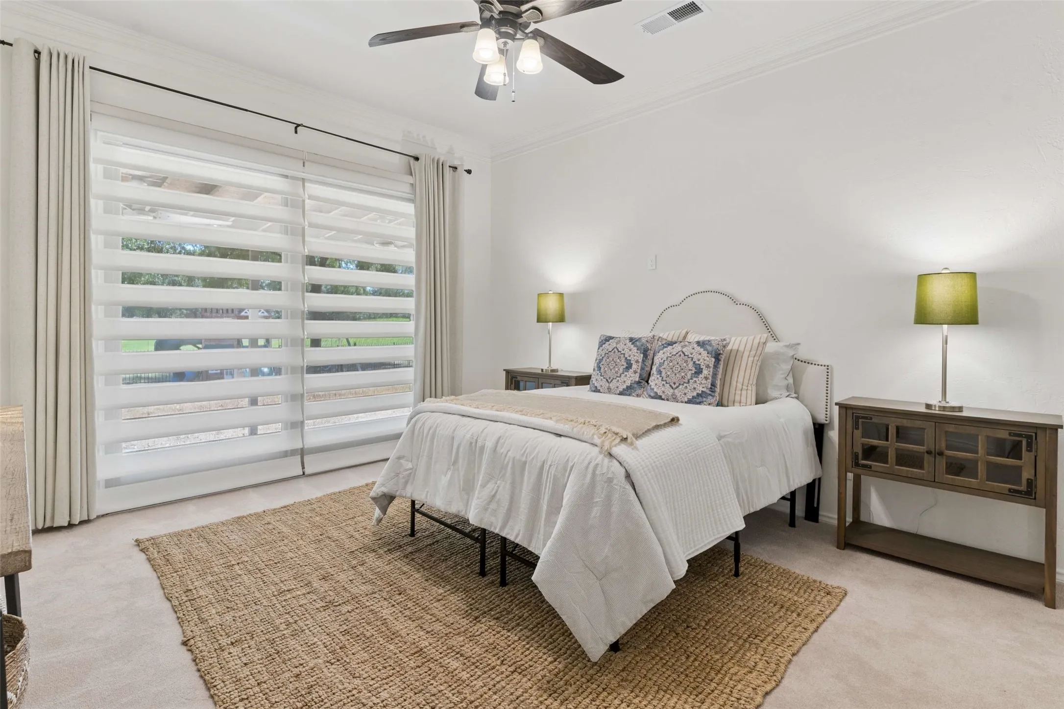 Recessed lighting, crown molding, ceiling fan, and large sliding glass doors