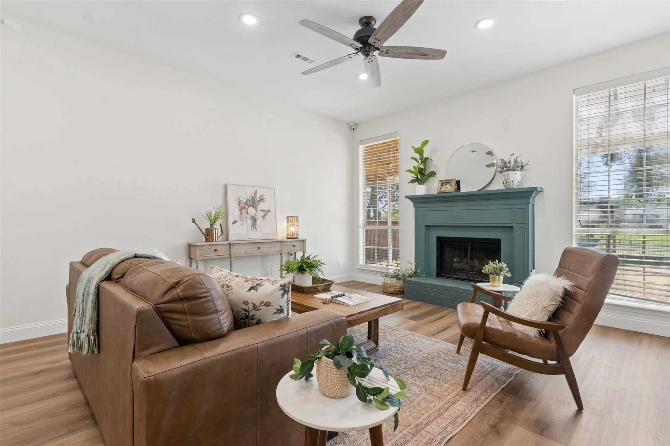Living area featuring wood-finish flooring, recessed lighting, and a ceiling fan