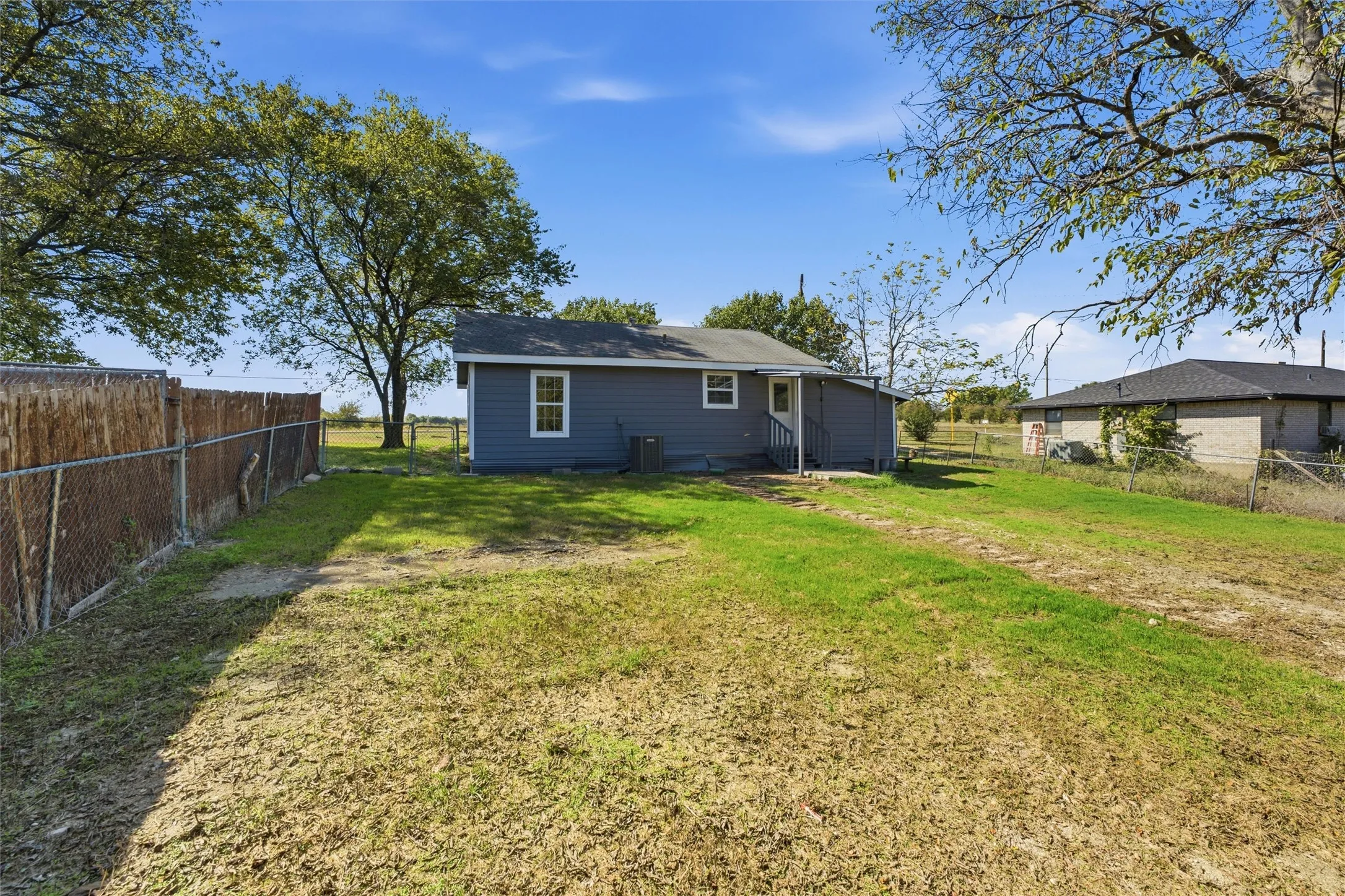 Back of structure showcasing quarter acre lot