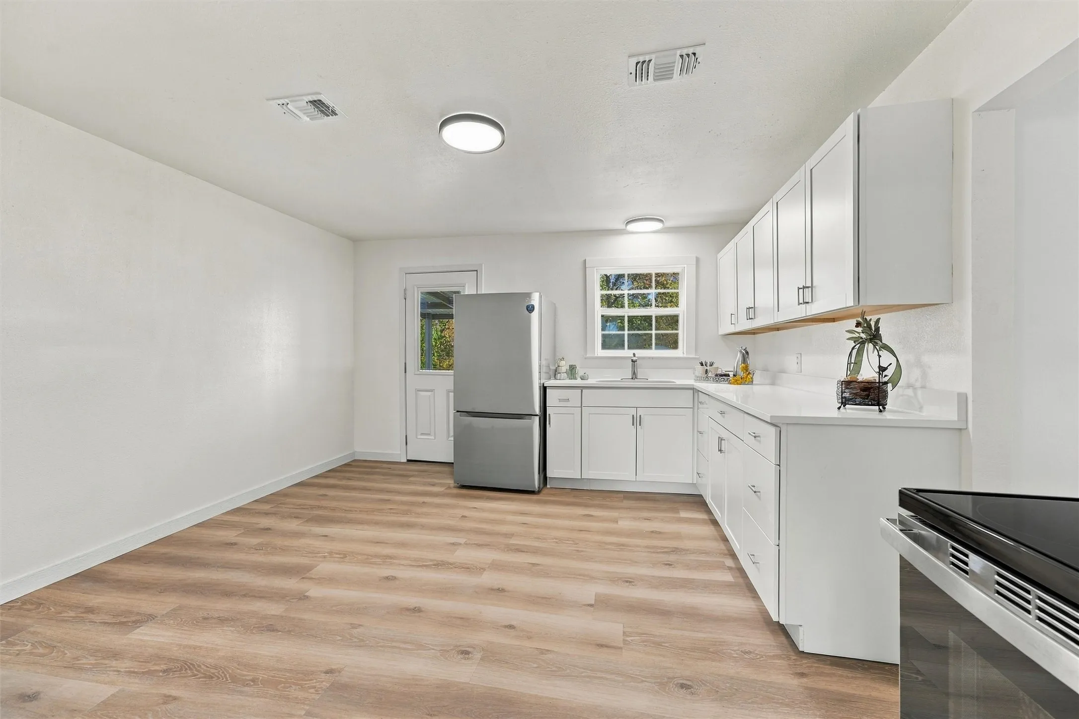 Updated kitchen featuring quartz countertops and new cabinets.