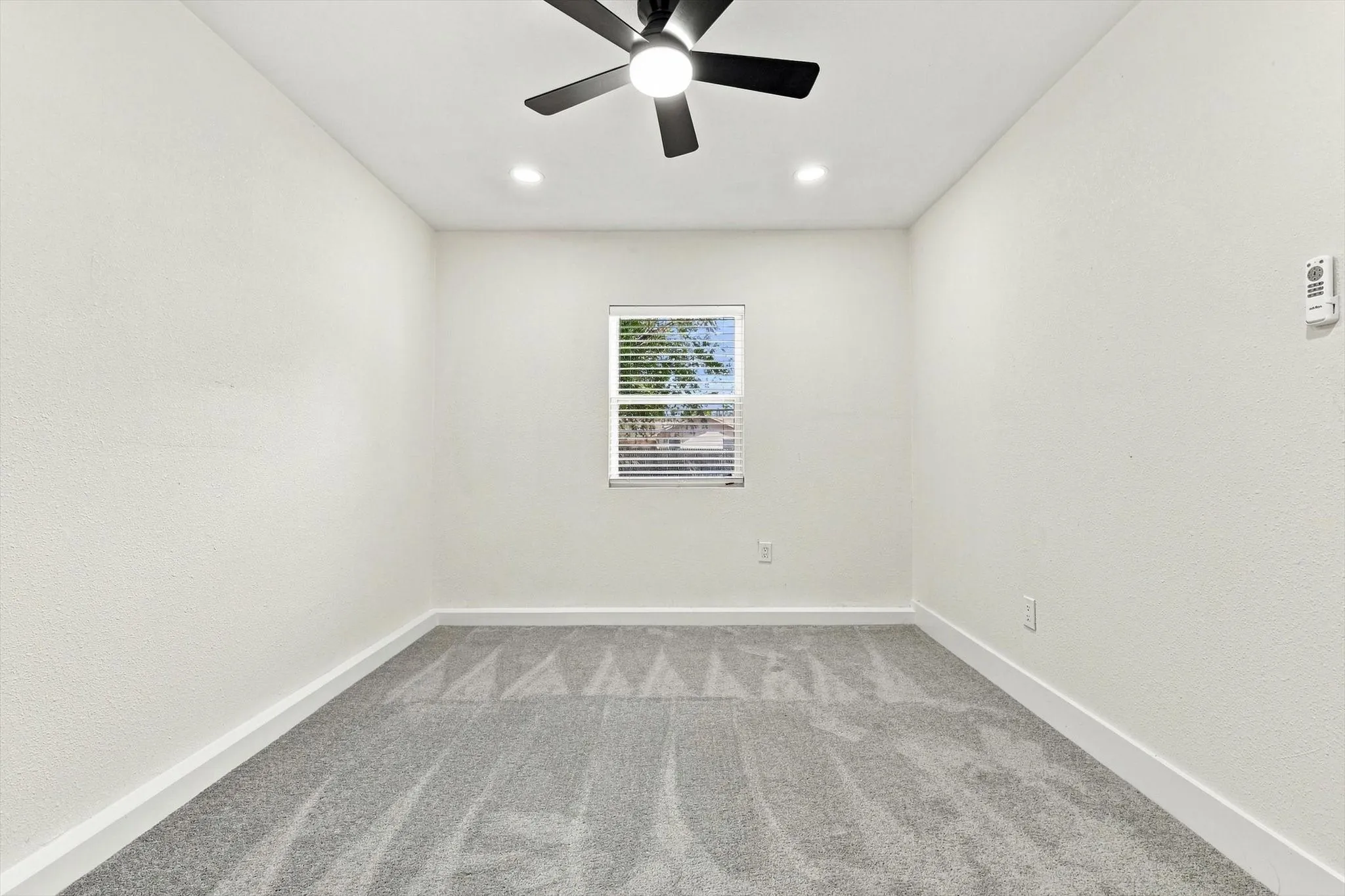Recessed lighting, ceiling fan, window with blinds, and gray carpet