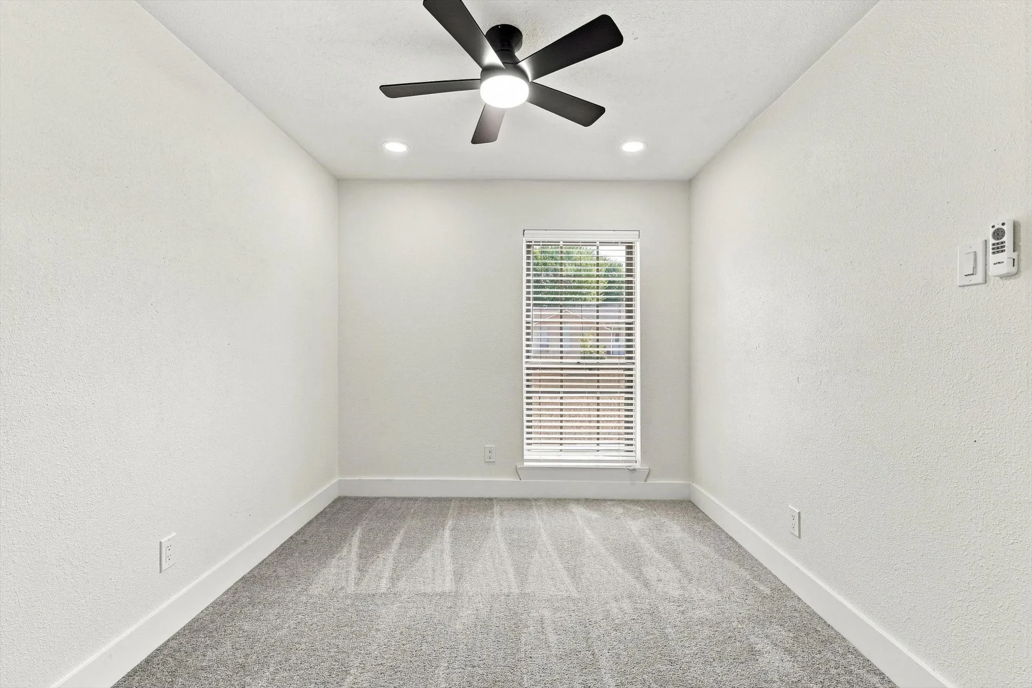 Recessed lighting, ceiling fan, window with blinds, and light gray carpeting
