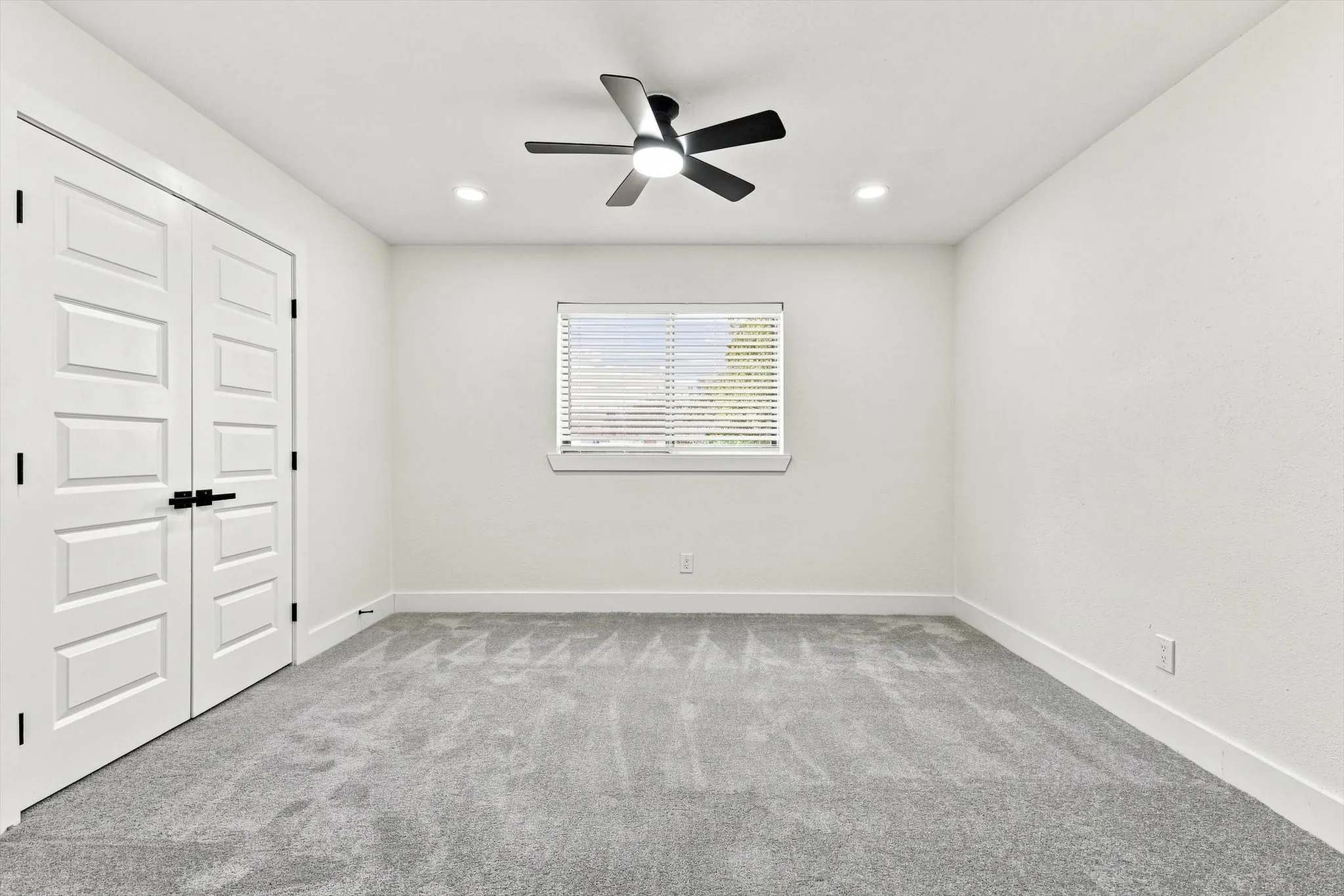 Neutral paint palette, recessed lighting, ceiling fan, window with blinds, and paneled double doors