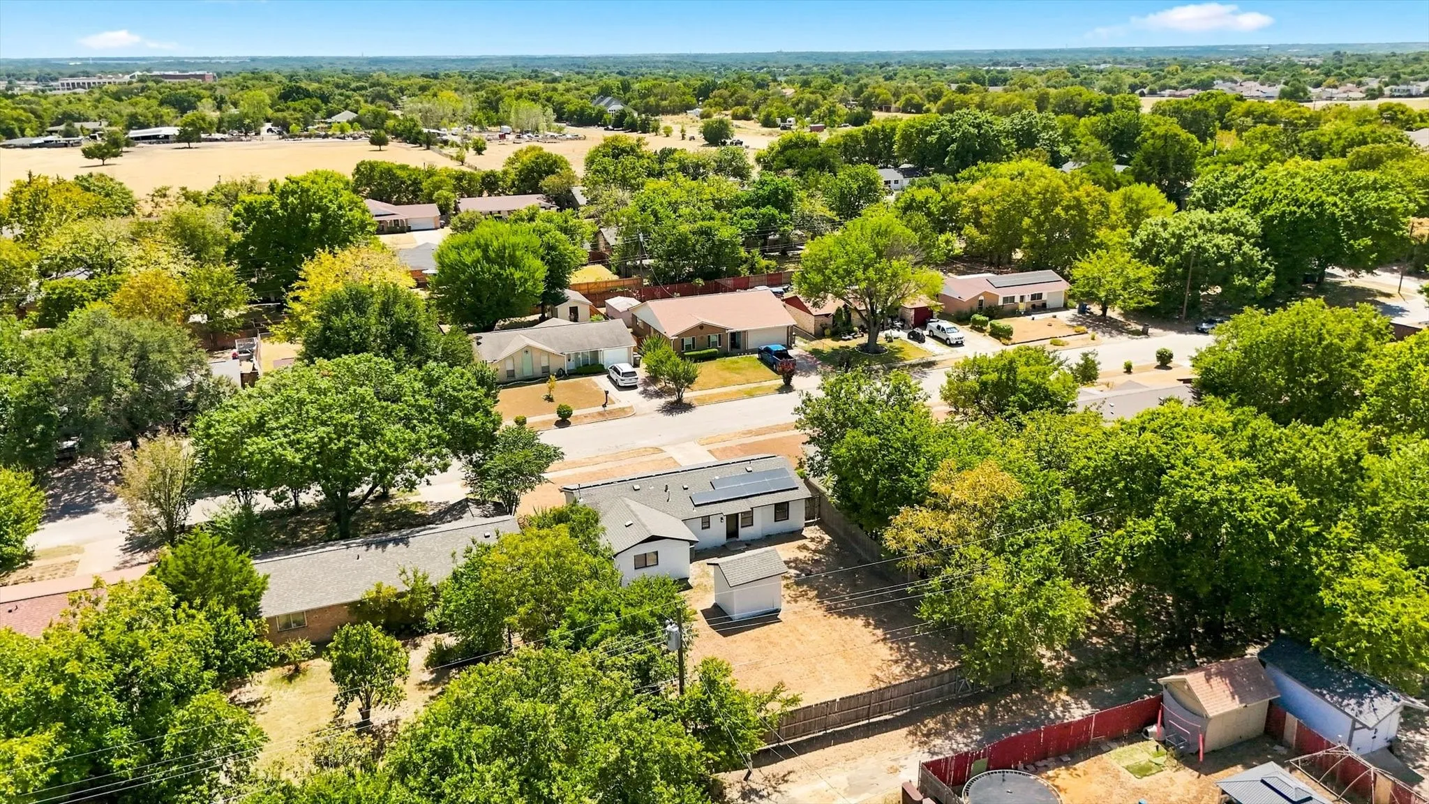 Neighborhood setting with mature trees and residential properties