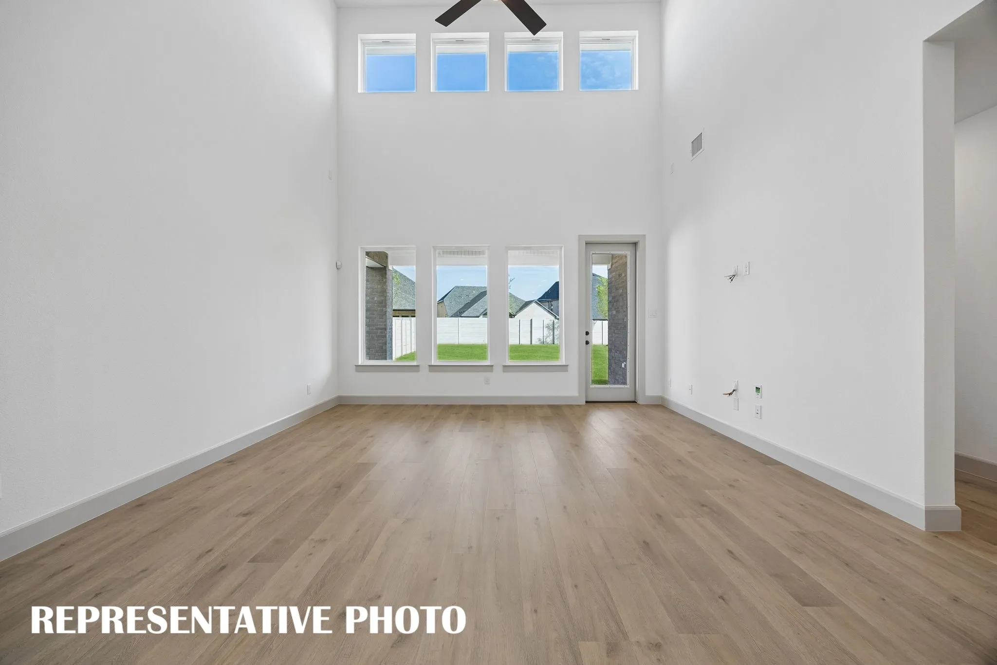 Light filled and offering a peaceful backyard view, you will love hosting family and friends in this wonderful family room.  REPRESENTATIVE PHOTO