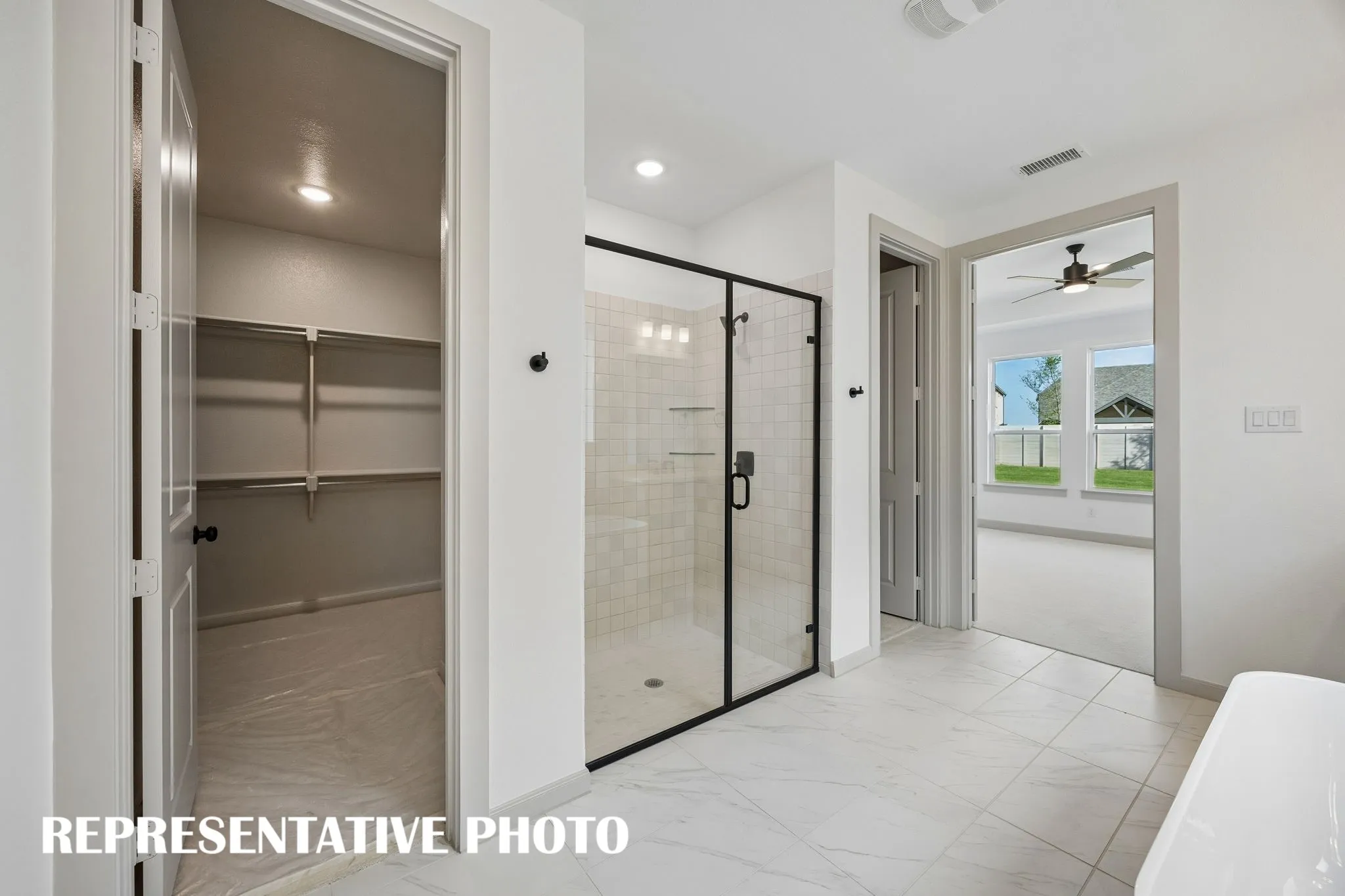 With a wonderful soaking tub, oversized walk in shower and wonderful his & hers closets, you will never want to leave this over the top owner's bath!  REPRESENTATIVE PHOTO
