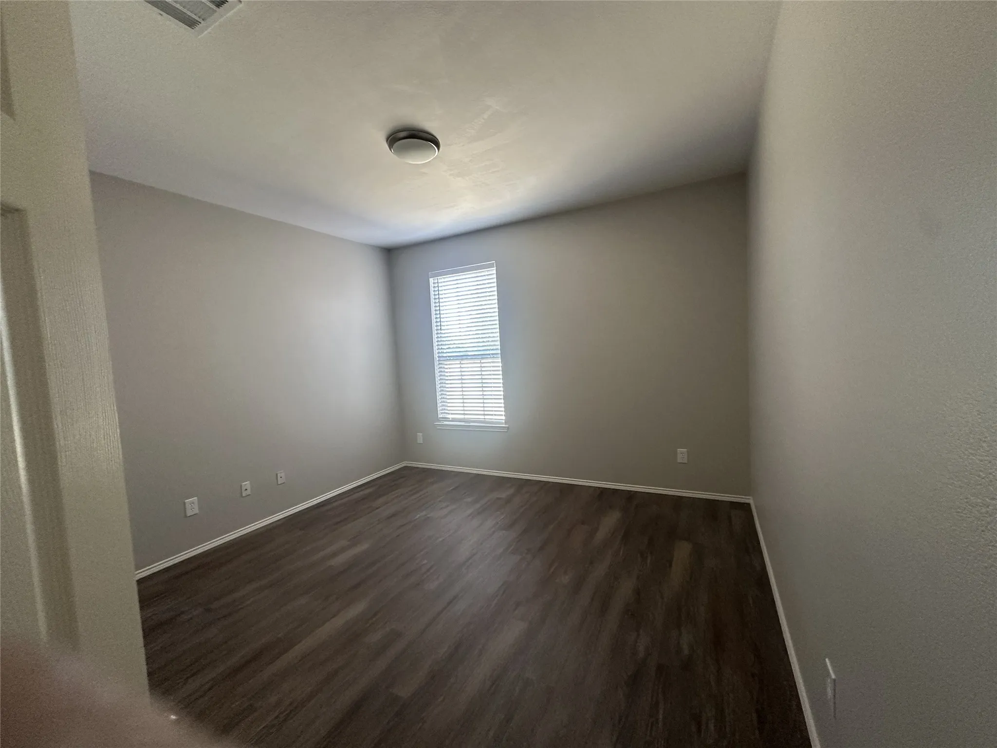 Neutral wall color with wood-finish flooring