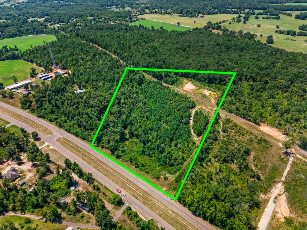 Wooded acreage with highway frontage