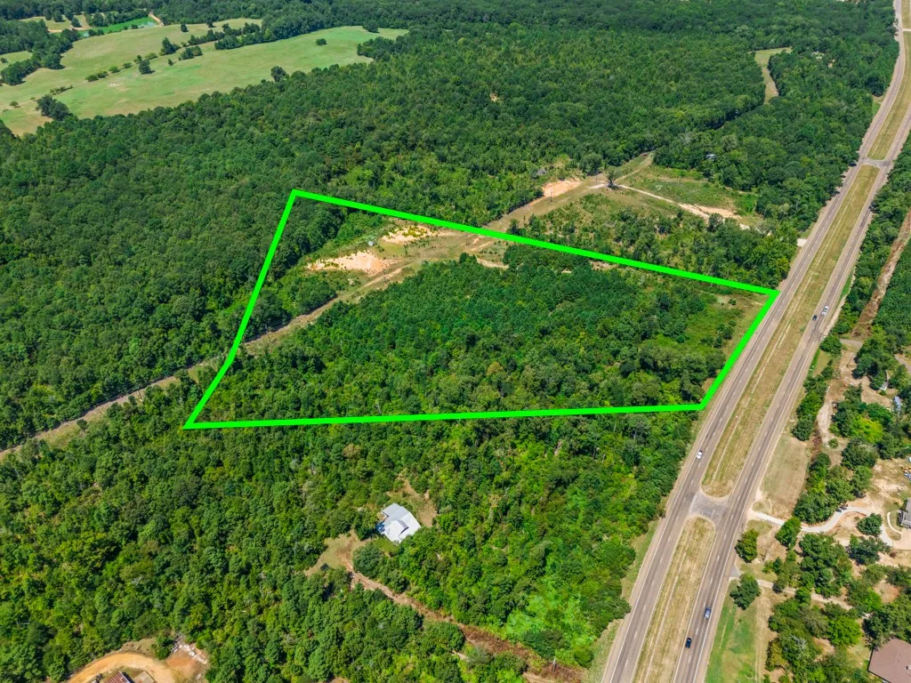 Wooded acreage with highway frontage