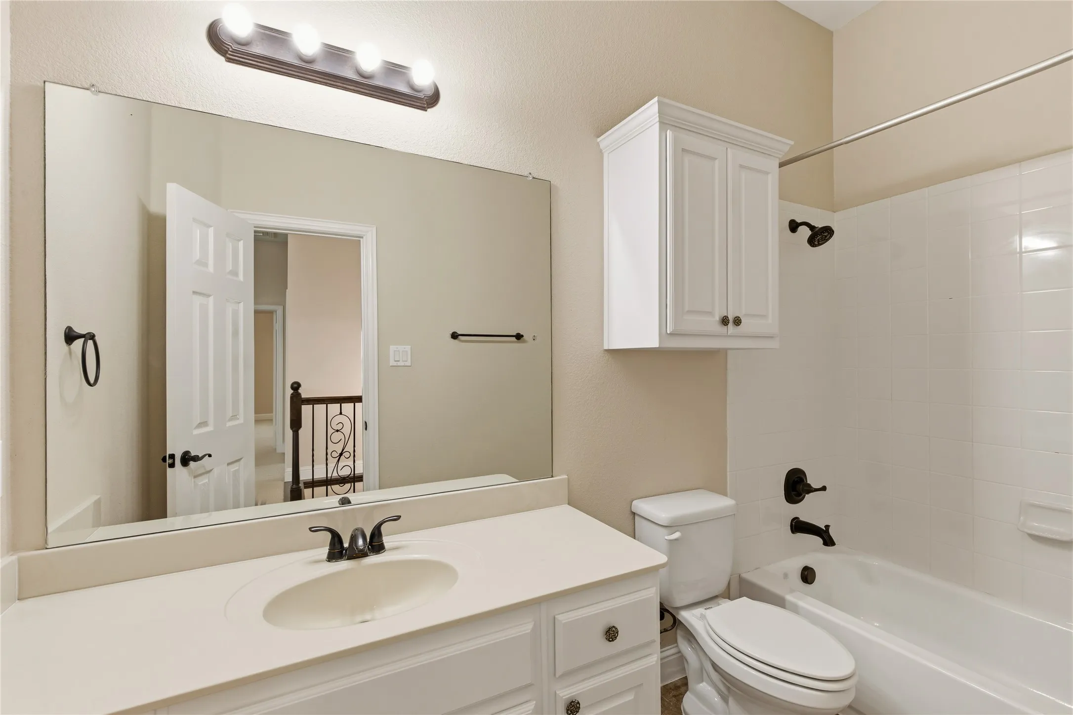 Bathroom vanity with an integrated sink and light-toned countertop