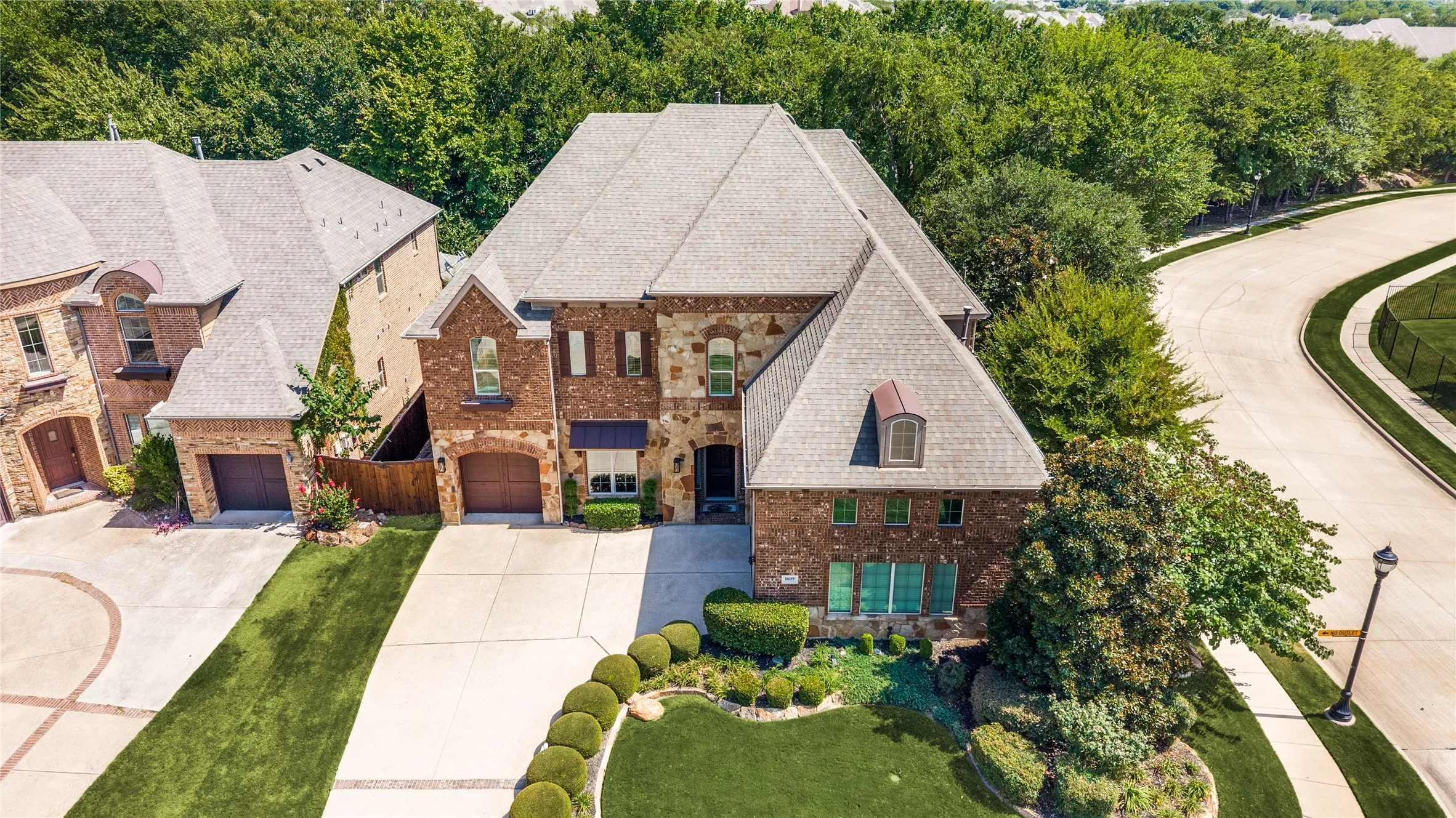 This image highlights the privacy afforded by the mature trees and the expansive nature of the corner lot.