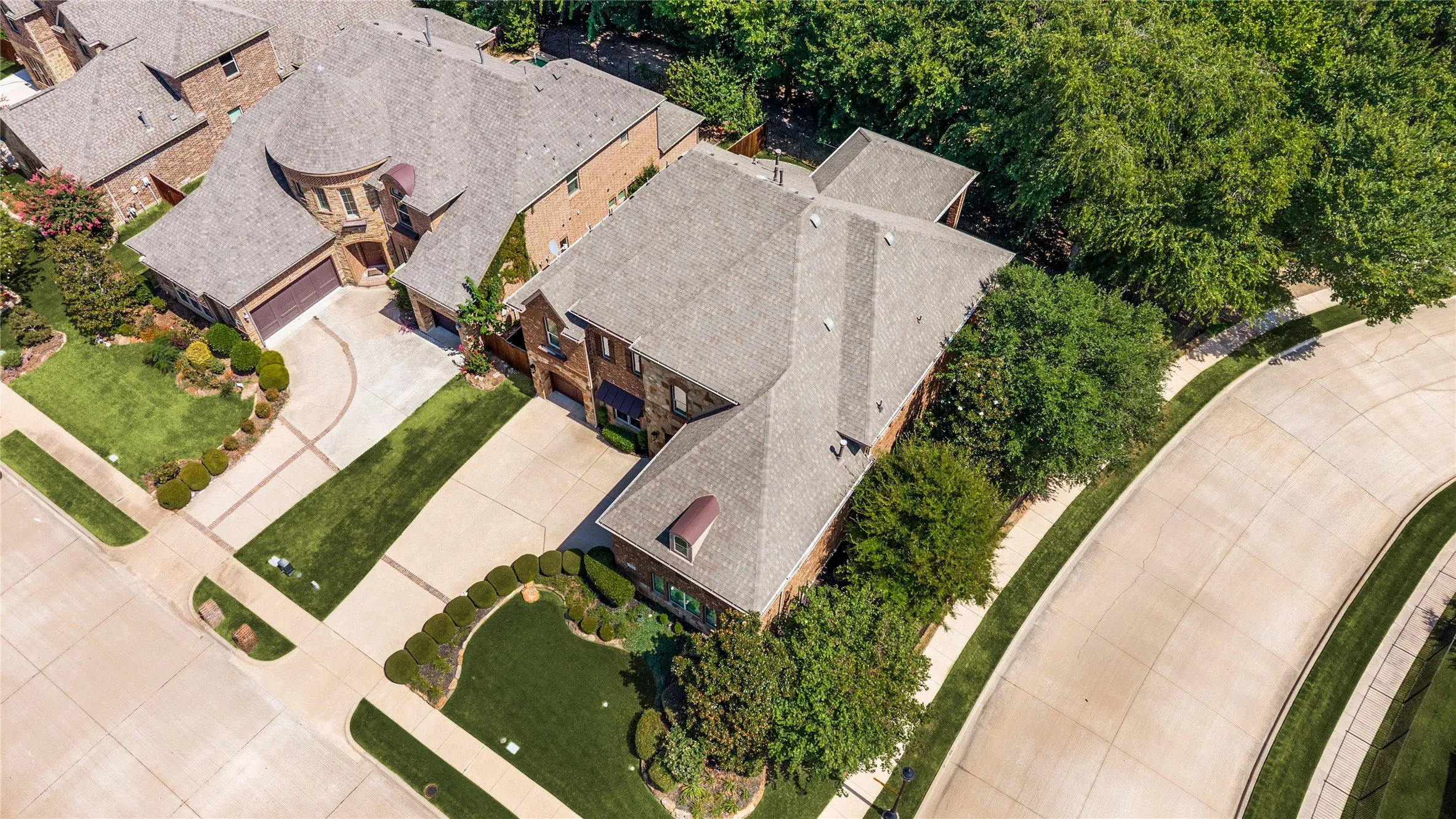 This home features custom landscaping and mature trees situated on a spacious corner lot; the community offers extensive walking and biking paths for residents.