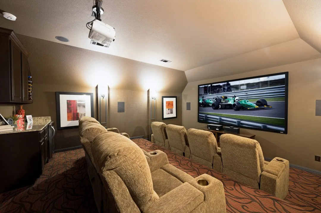 Fabulous Bi-level 8-Seat Home Theater featuring a ceiling-mounted projector, screen, built-in cabinetry with granite countertops and wine refrigerator.
