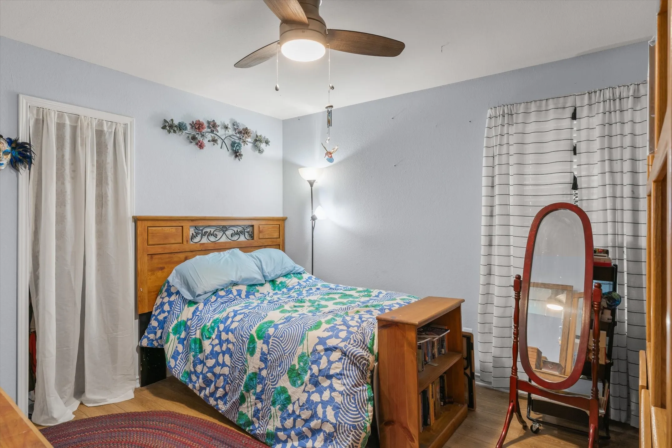 Wood-finish flooring with a ceiling fan and light fixture