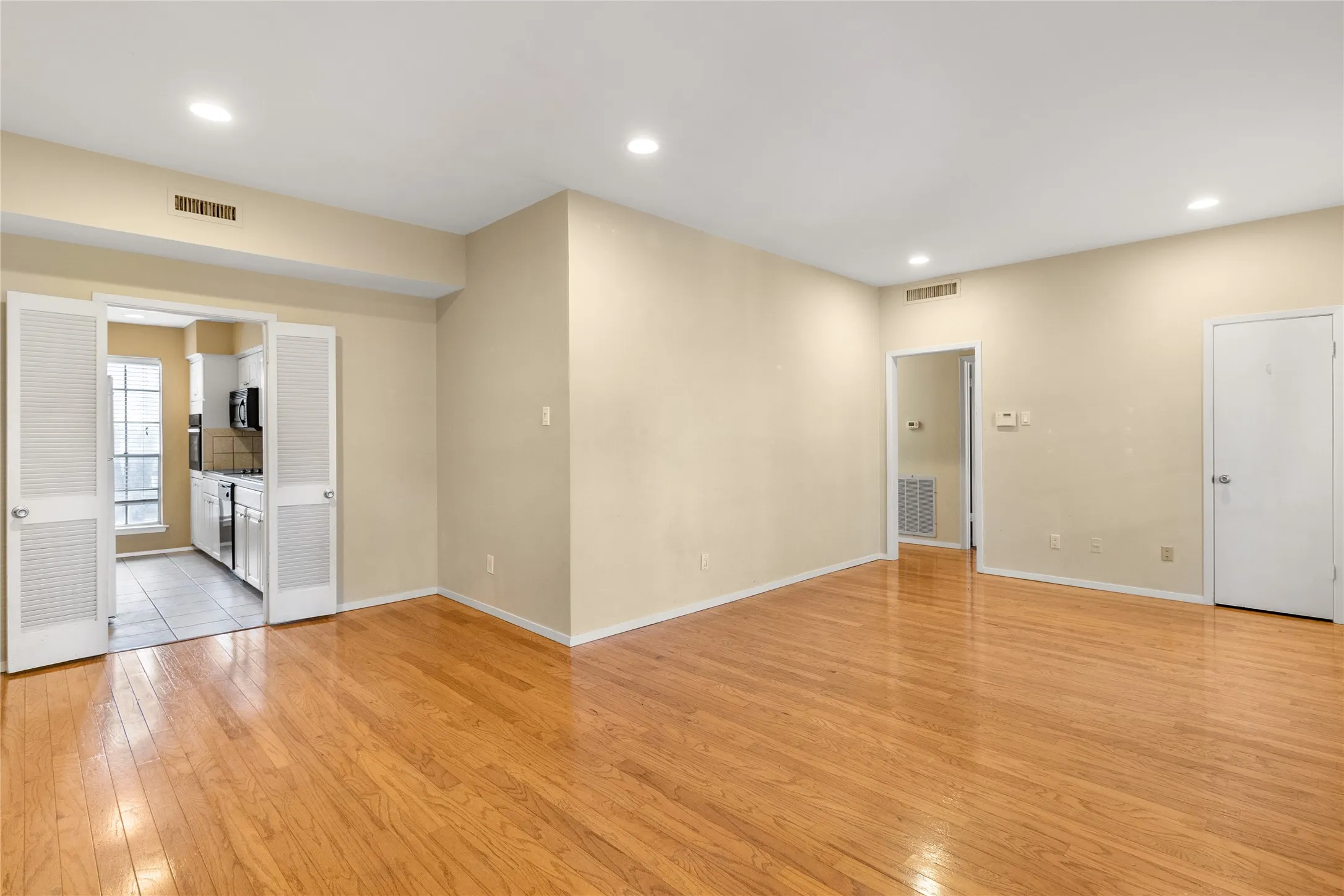 Living room with recessed lighting and light wood-type flooring