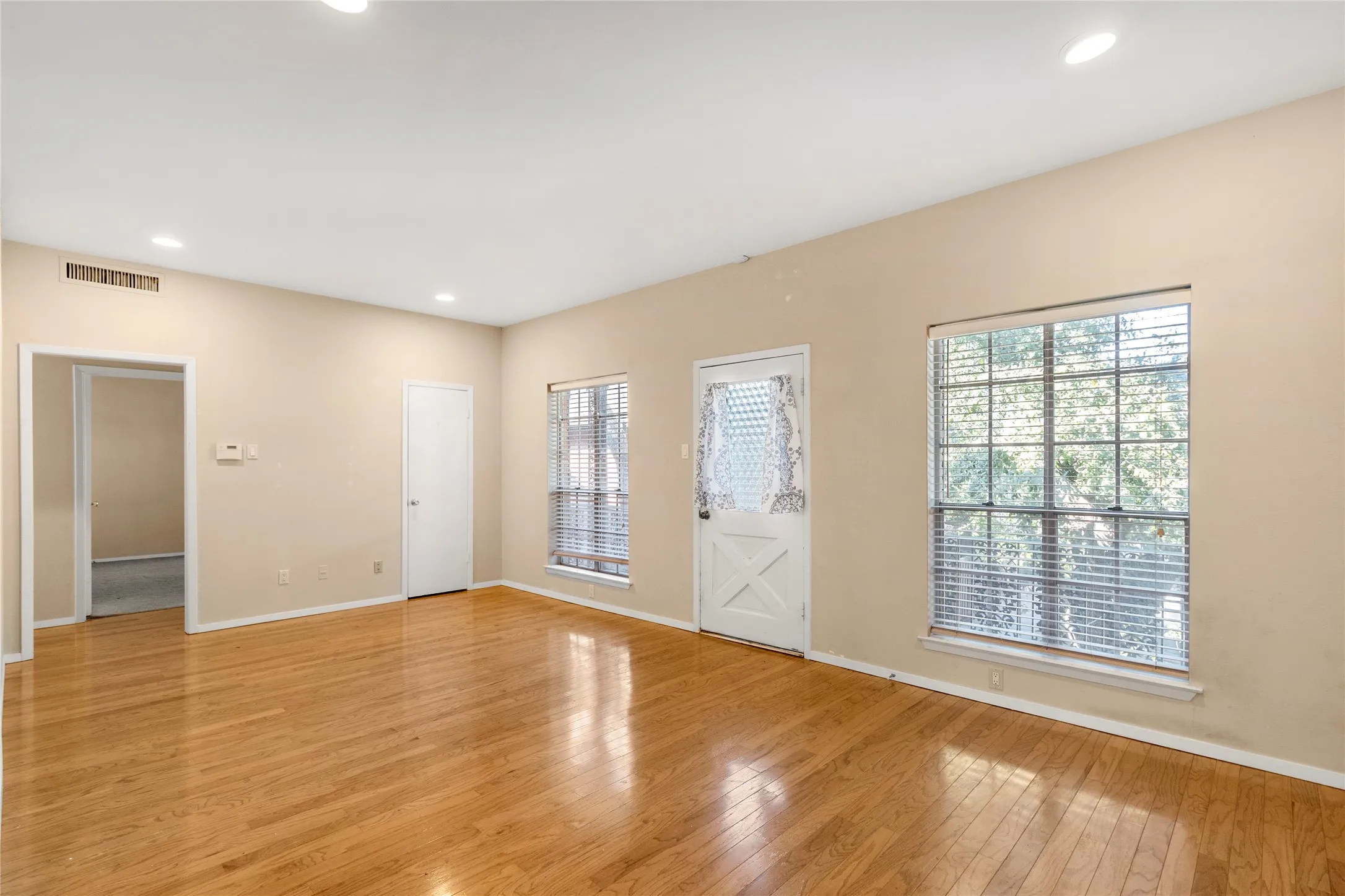 Living room with recessed lighting and light wood-type flooring