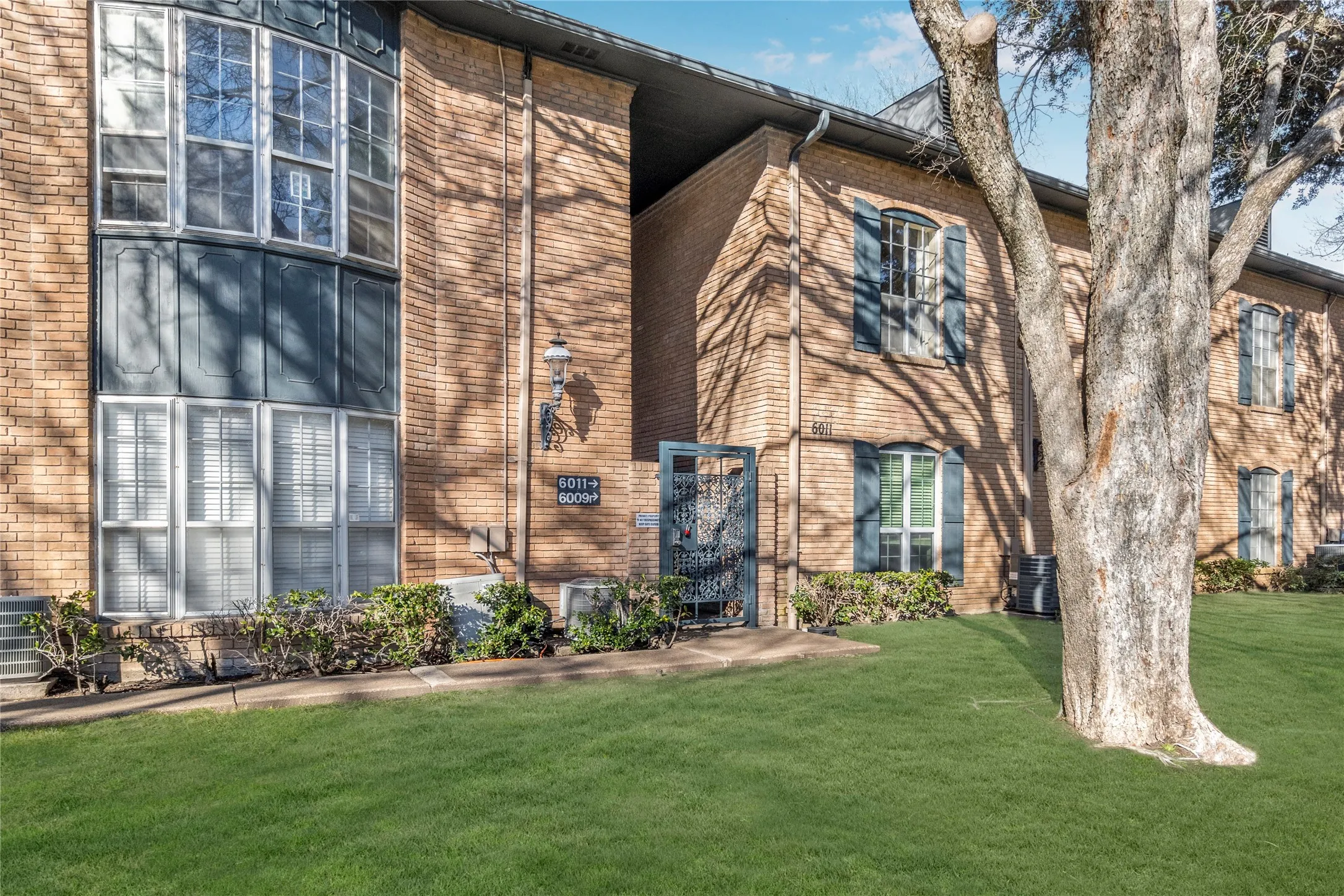 View of front facade featuring brick siding and a front yard