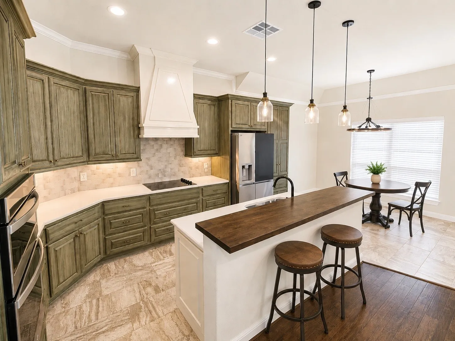 Kitchen featuring distressed green cabinetry, light-colored countertops, a tile backsplash, and a built-in range