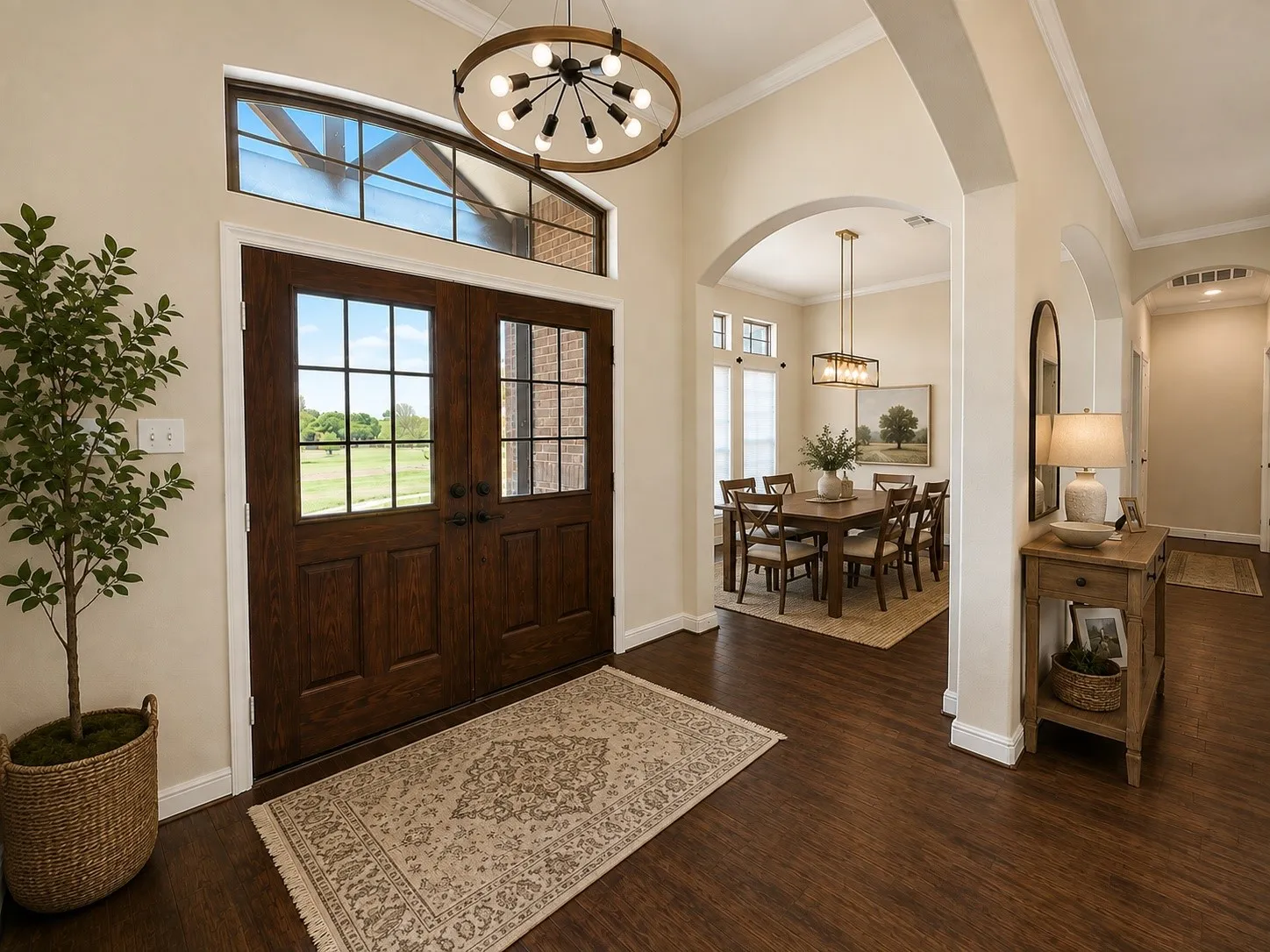 Double entry doors with divided lites and an arched transom window