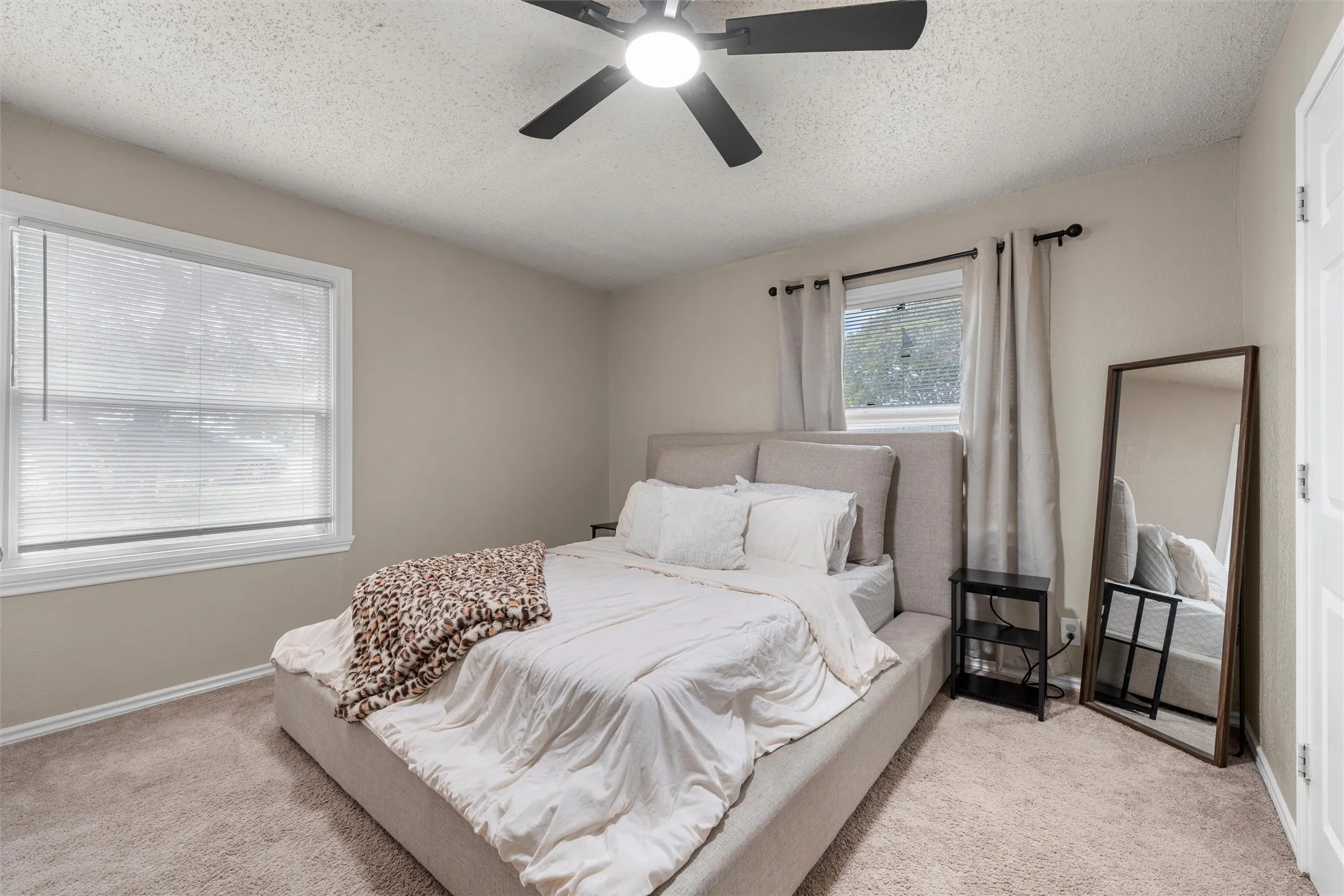 Neutral-toned walls complement plush carpeting