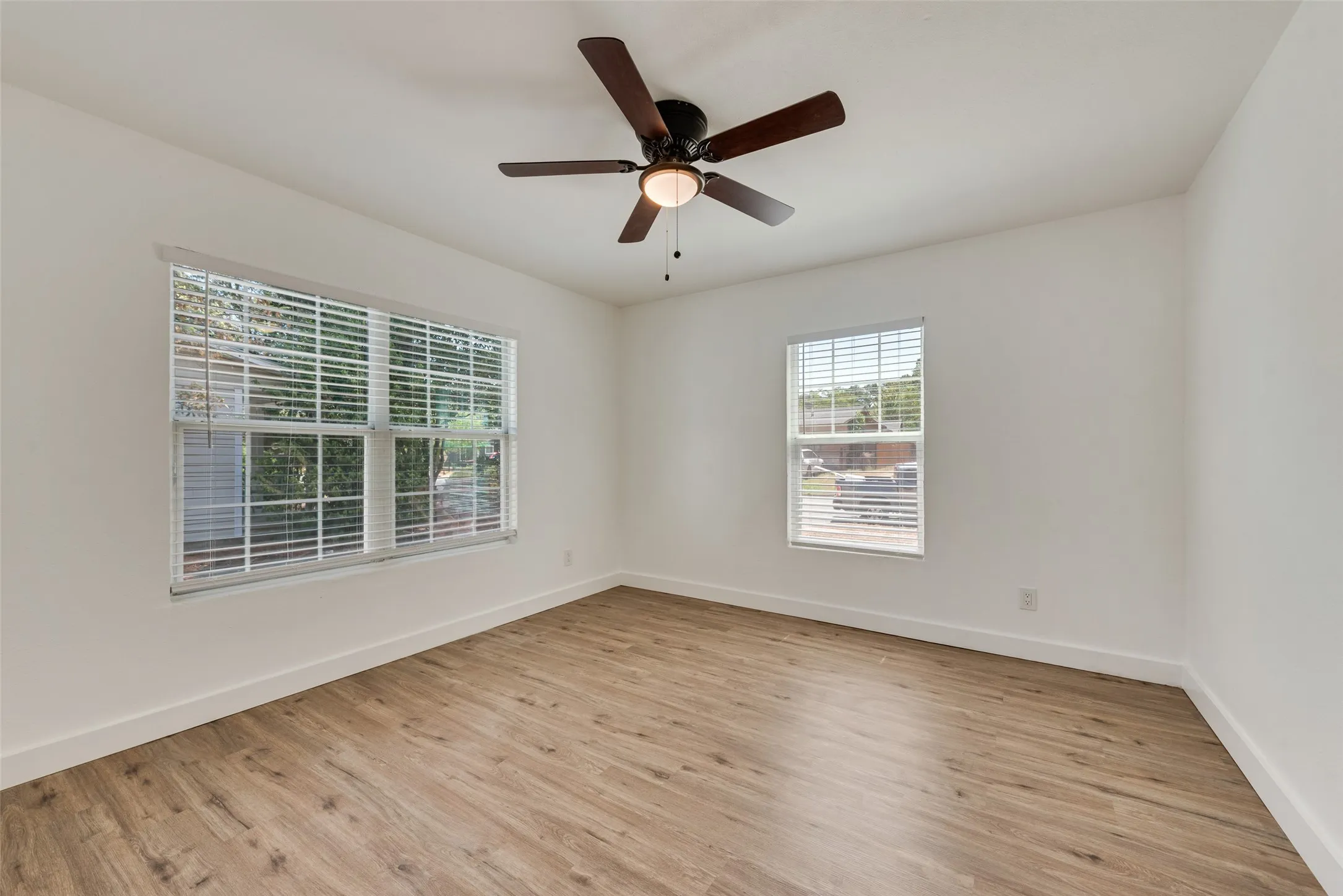 Recessed lighting, ceiling fan with light fixture, wood-finish flooring, and white walls