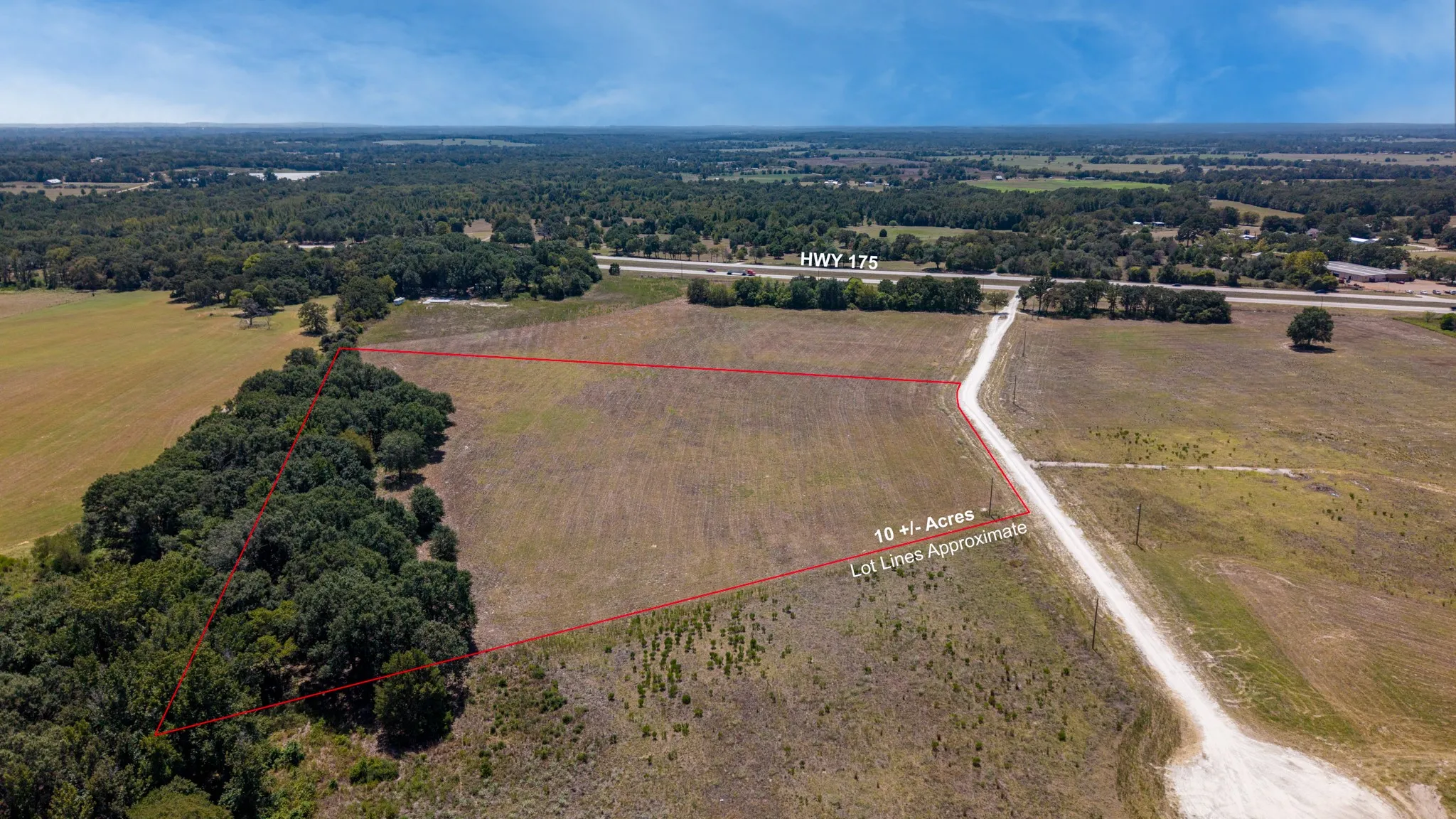 Expansive acreage featuring highway frontage and surrounding mature trees