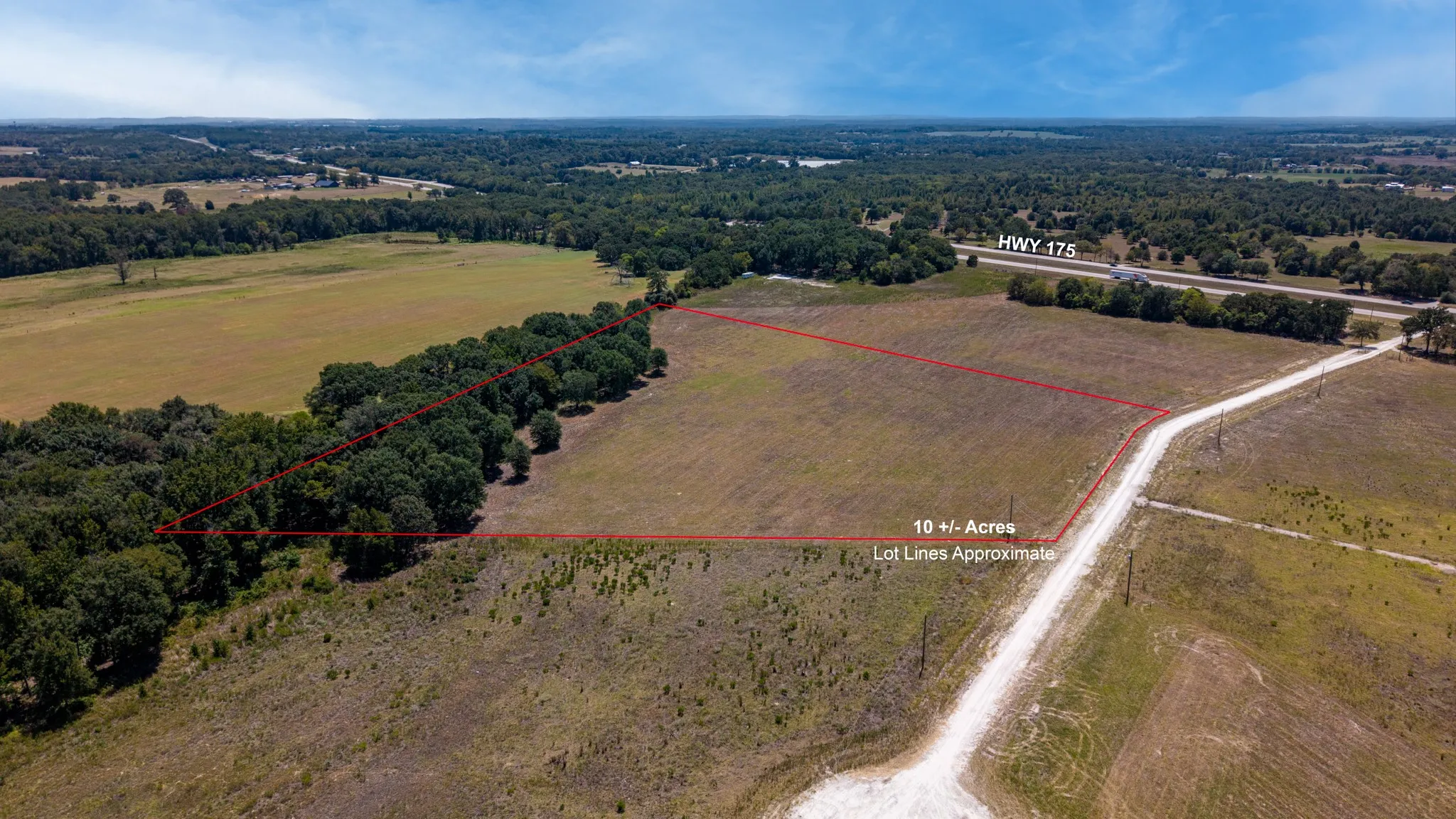 Expansive acreage featuring a partially wooded perimeter and direct road frontage