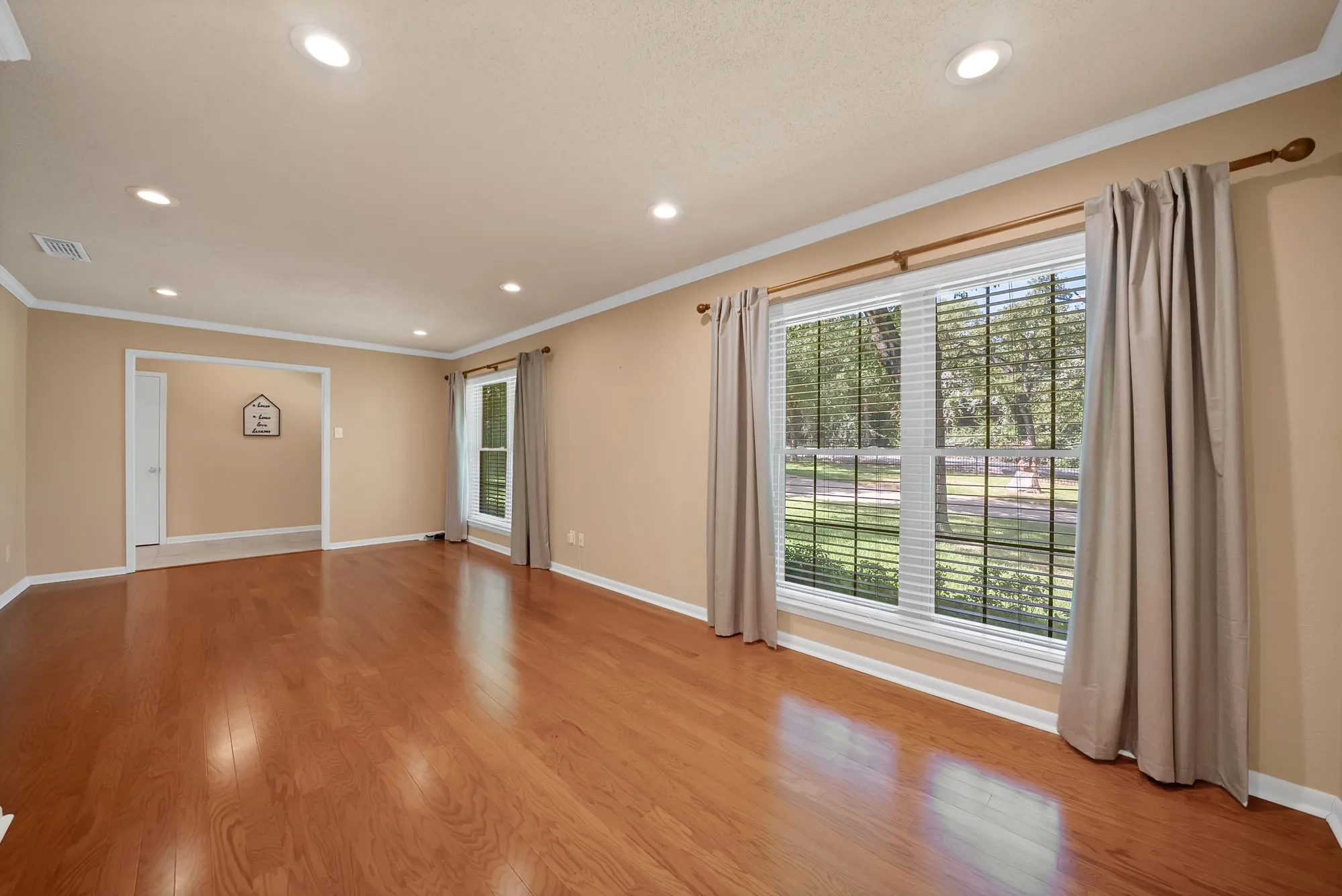 large living room, recessed lights, wood finish